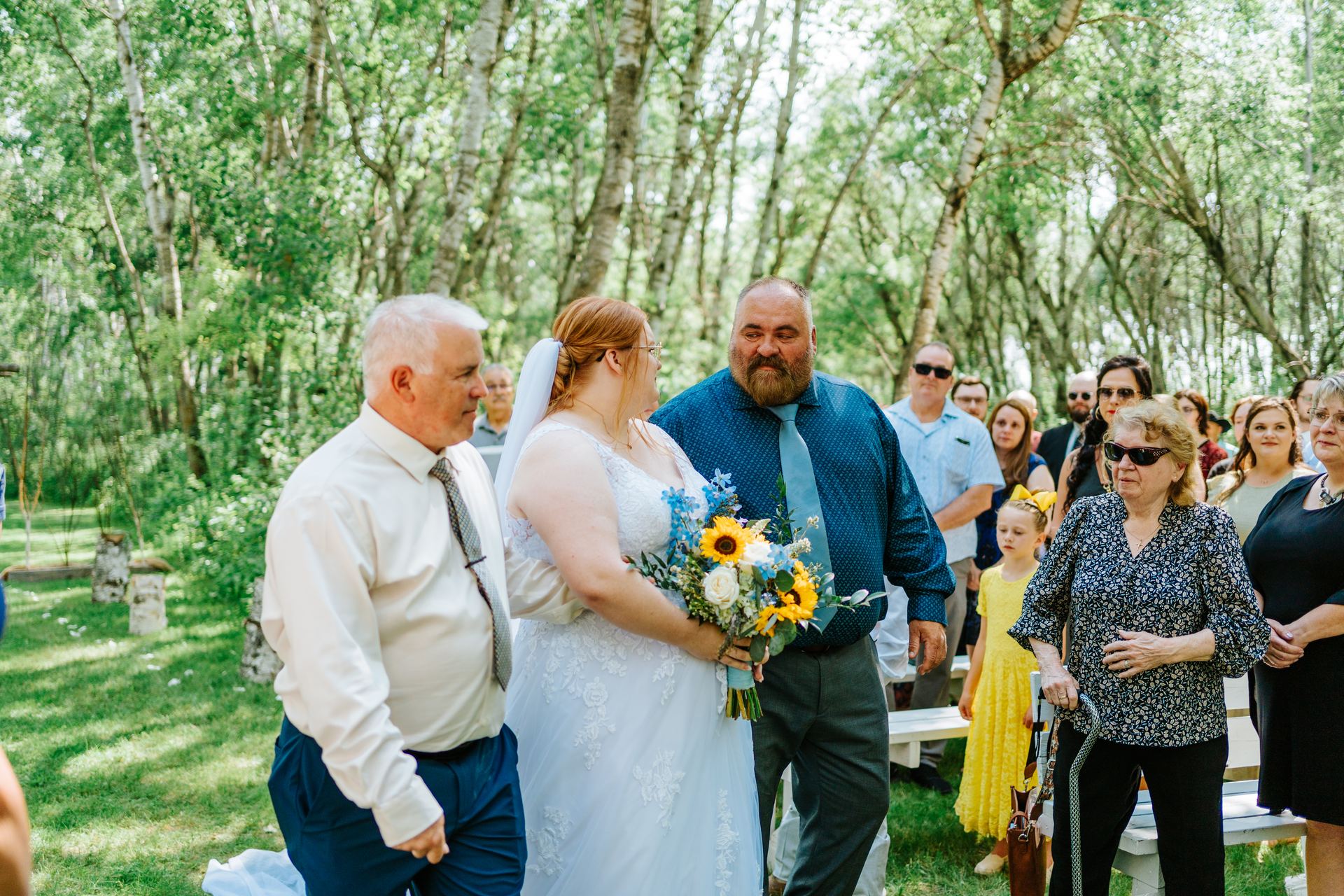 Bride Alysia walking the processional through the birch forest — Deer Meadow Farm Manitoba wedding photography