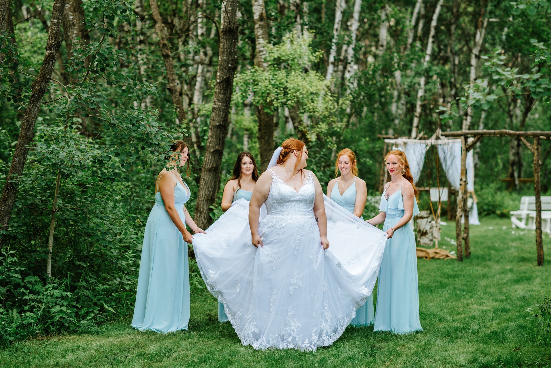 Bride Alysia with sunflower bouquet in the birch forest at Deer Meadow Farm Manitoba
