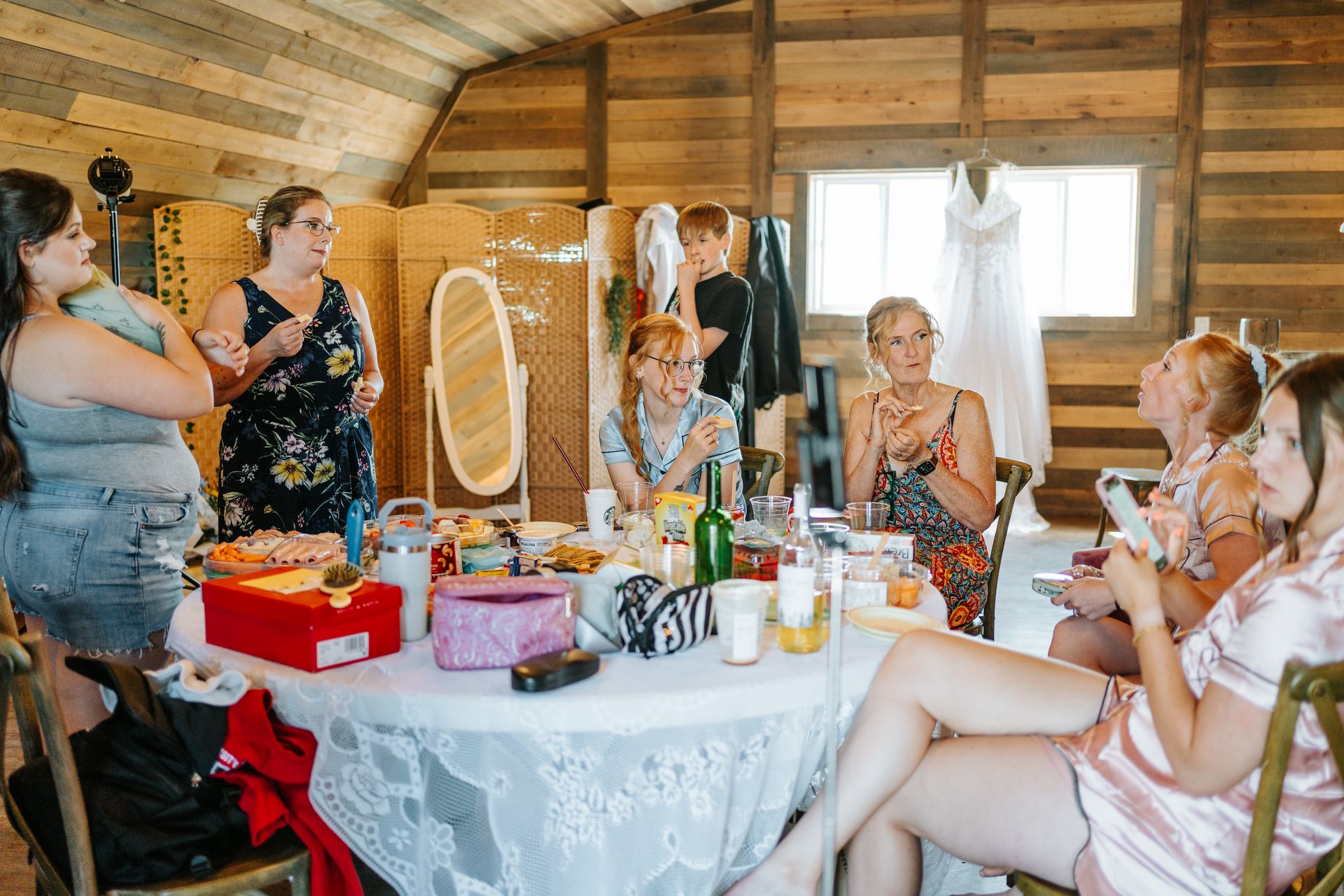 Bride Alysia and bridesmaids getting ready together in the barn at Deer Meadow Farm Manitoba