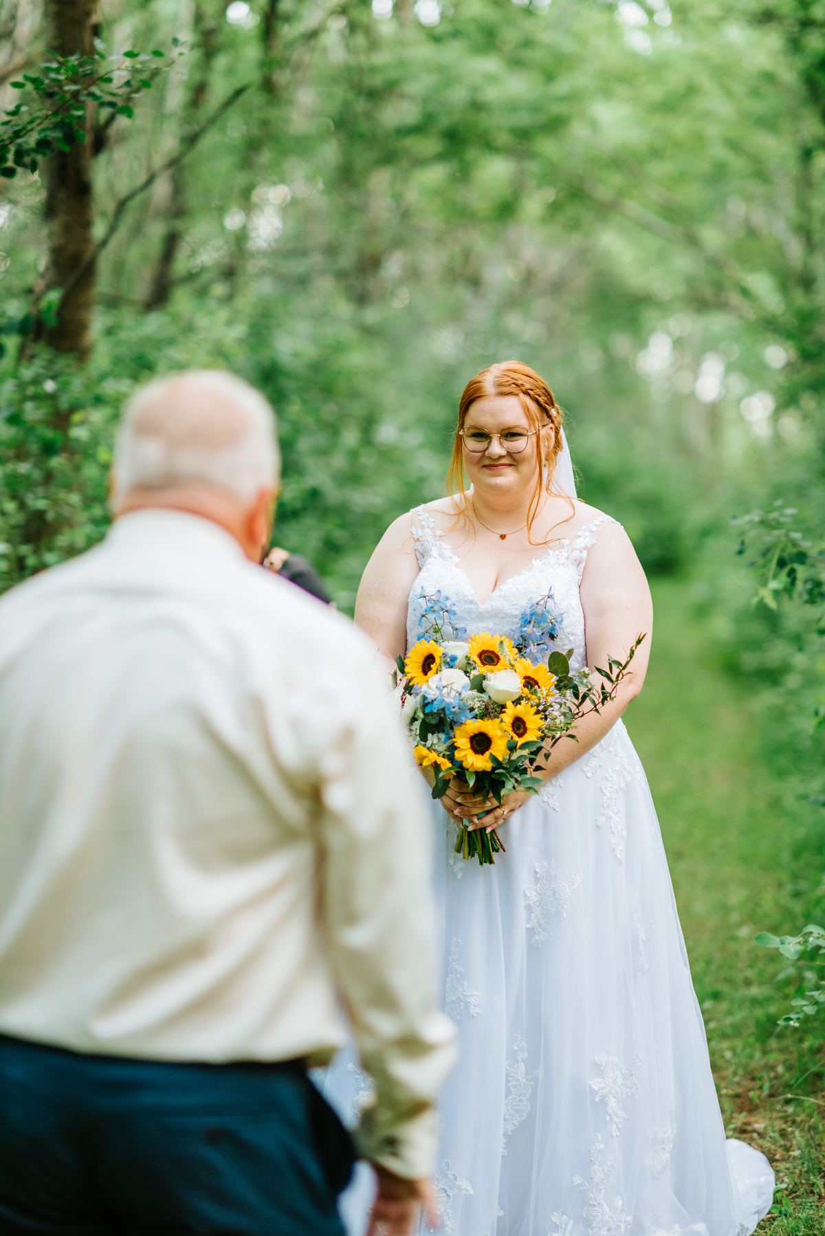 Bridesmaids fixing flower crown for bride Alysia in birch forest — Deer Meadow Farm Manitoba wedding
