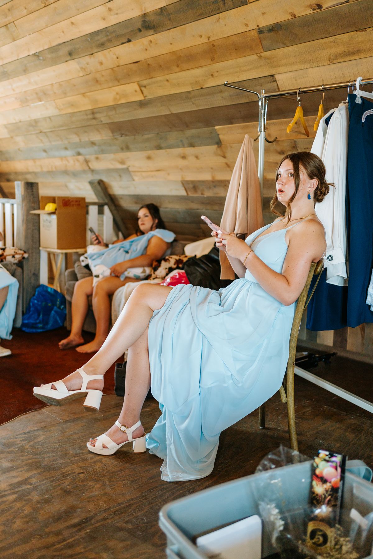 Bridesmaids in powder blue dresses getting ready together at Deer Meadow Farm Manitoba wedding