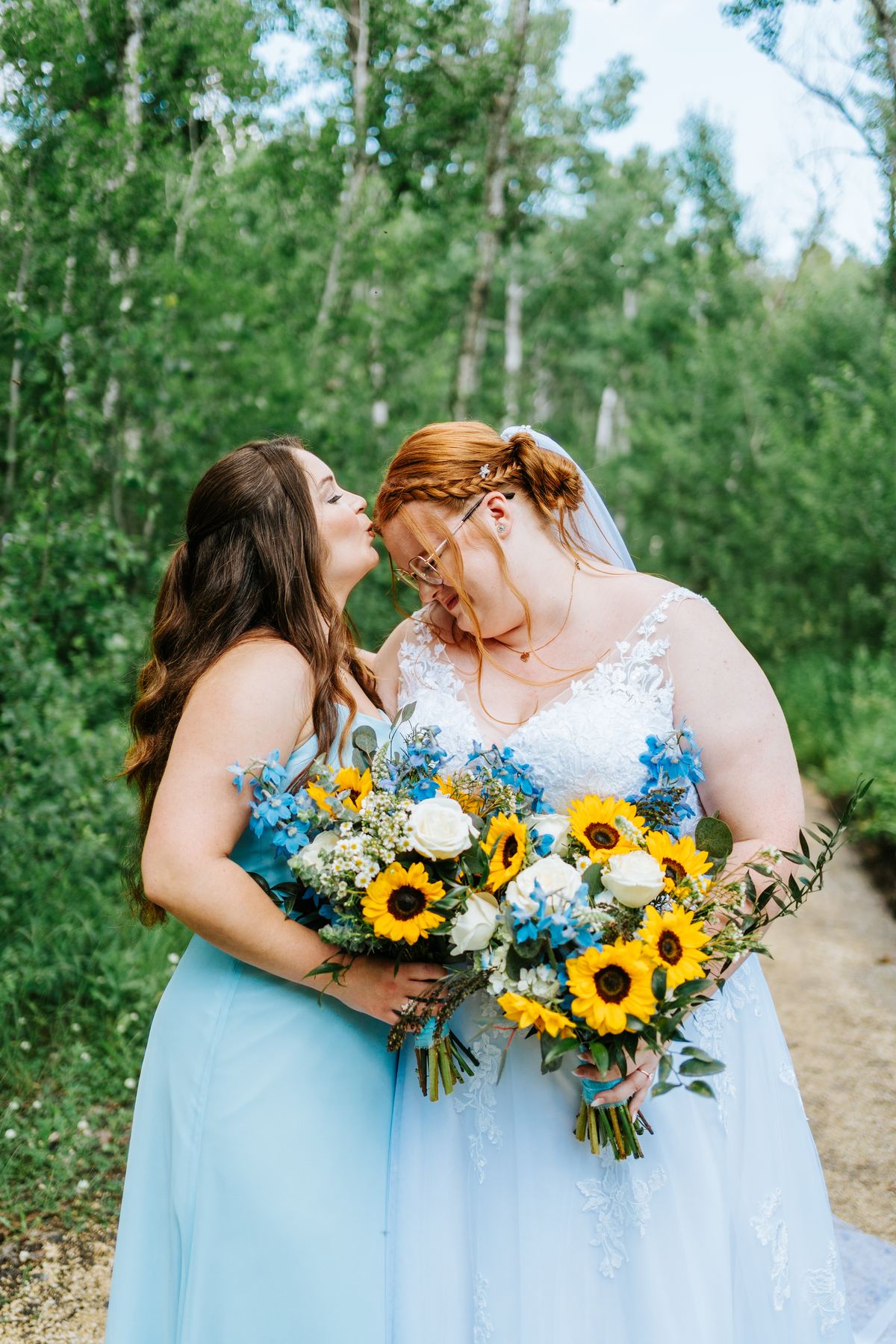 Bridesmaids with sunflower bouquets in the birch forest at Deer Meadow Farm Manitoba wedding