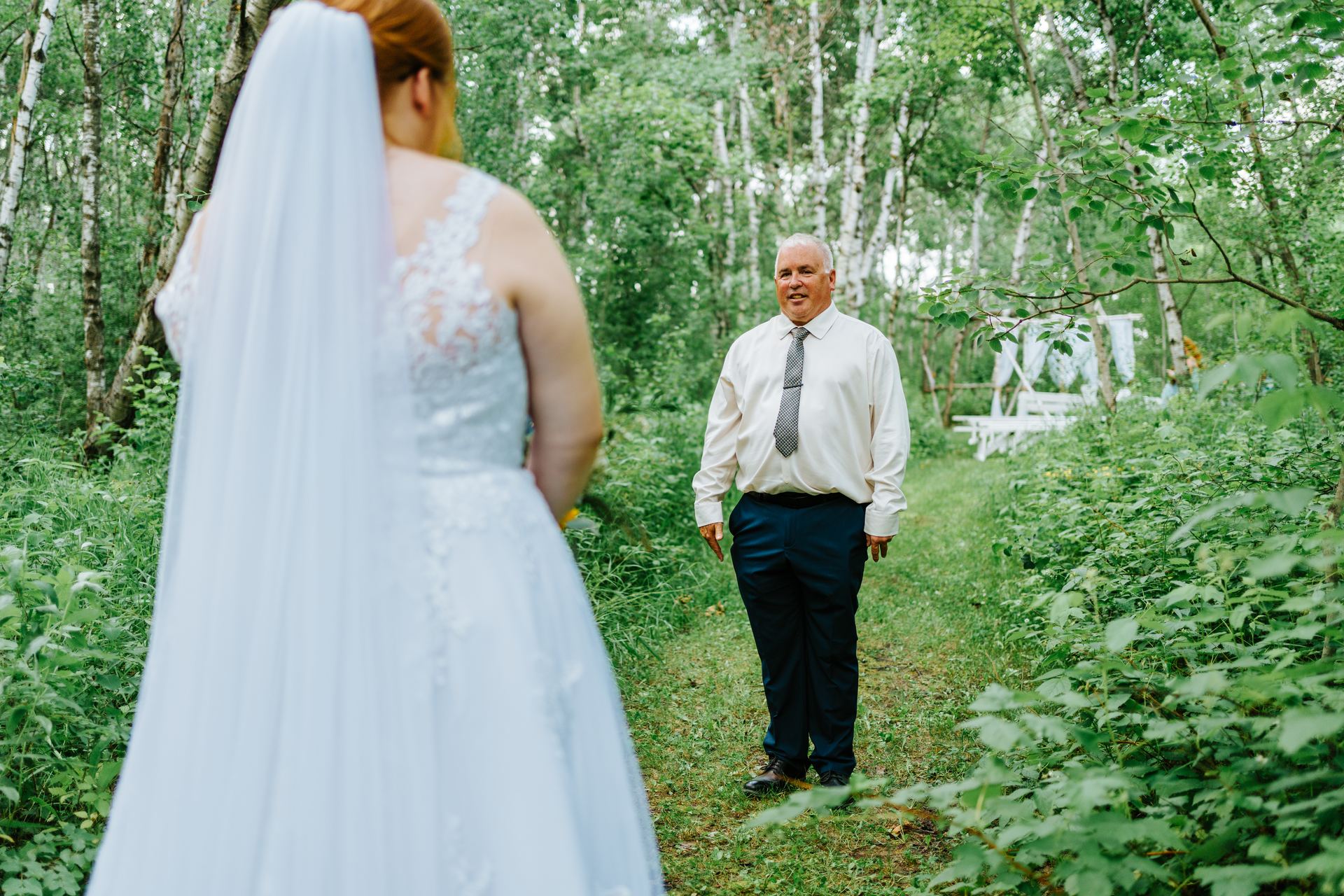 Processional walking down the birch forest grass aisle at Deer Meadow Farm Manitoba — wedding photography by Chris Ngo