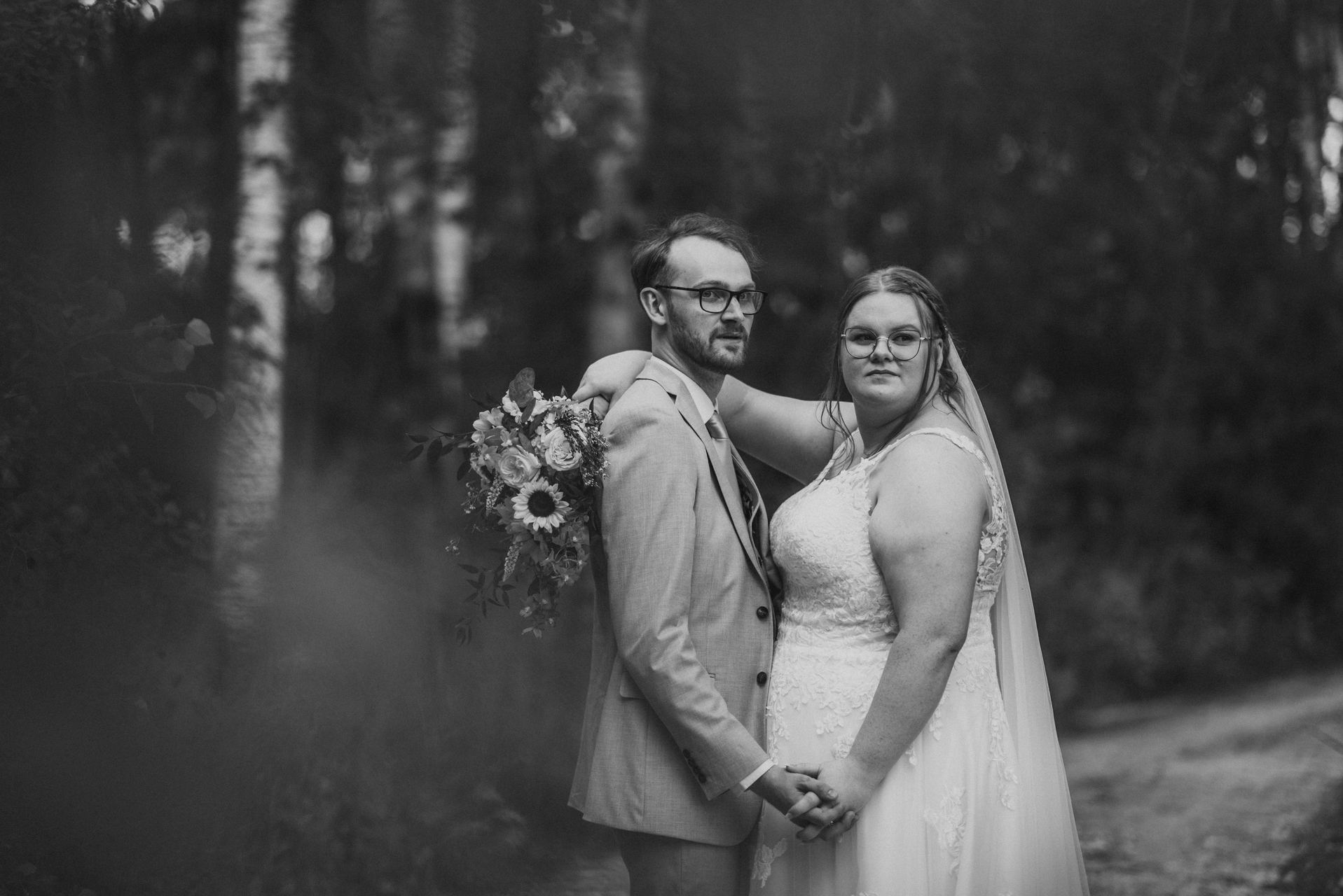 Alysia and Josh portrait in birch forest with sunflower bouquet — Deer Meadow Farm Manitoba wedding