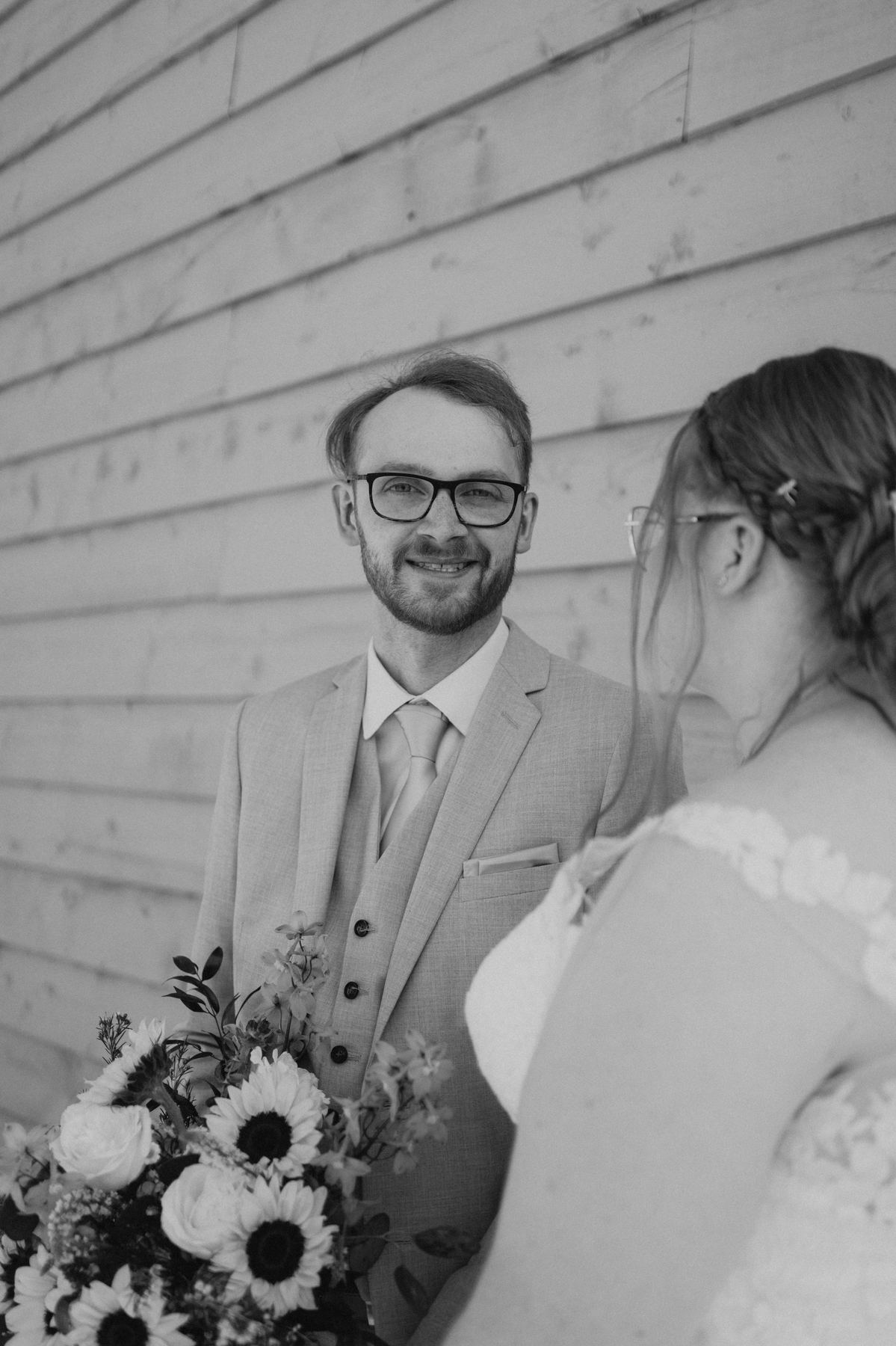 Black and white couple portrait kissing in the birch forest at Deer Meadow Farm Manitoba