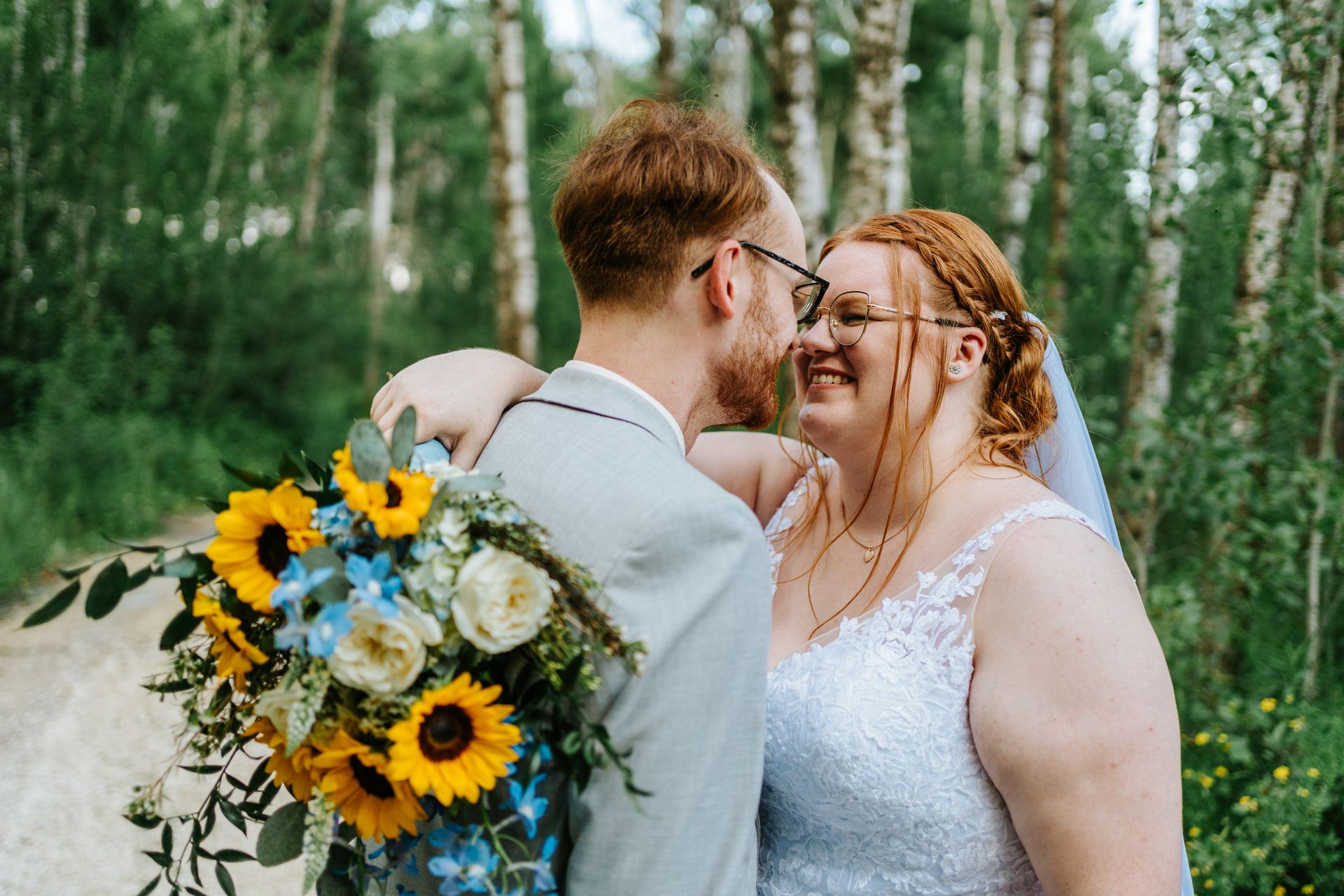 Alysia and Josh laughing together in the birch forest — Deer Meadow Farm Manitoba wedding photography