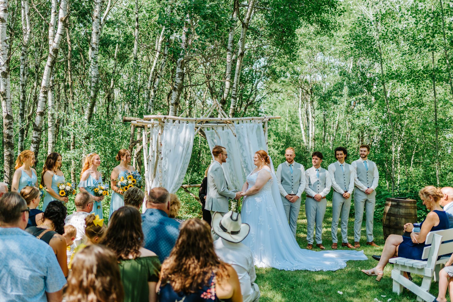 Intimate close portrait of Alysia and Josh during their vows at the log arbor — Deer Meadow Farm Manitoba wedding