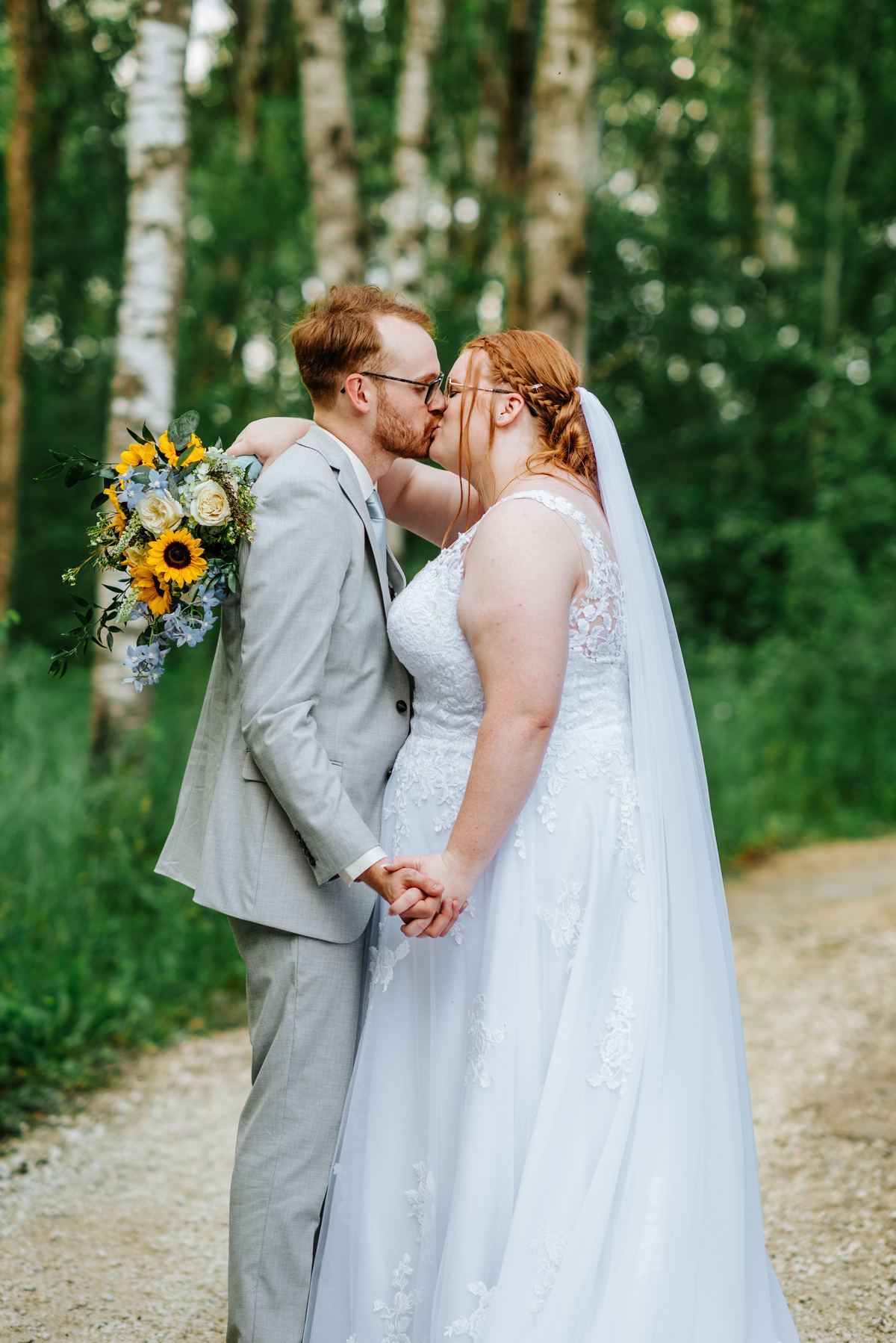 Alysia and Josh walking the birch forest path at Deer Meadow Farm Manitoba — wedding photography by Chris Ngo