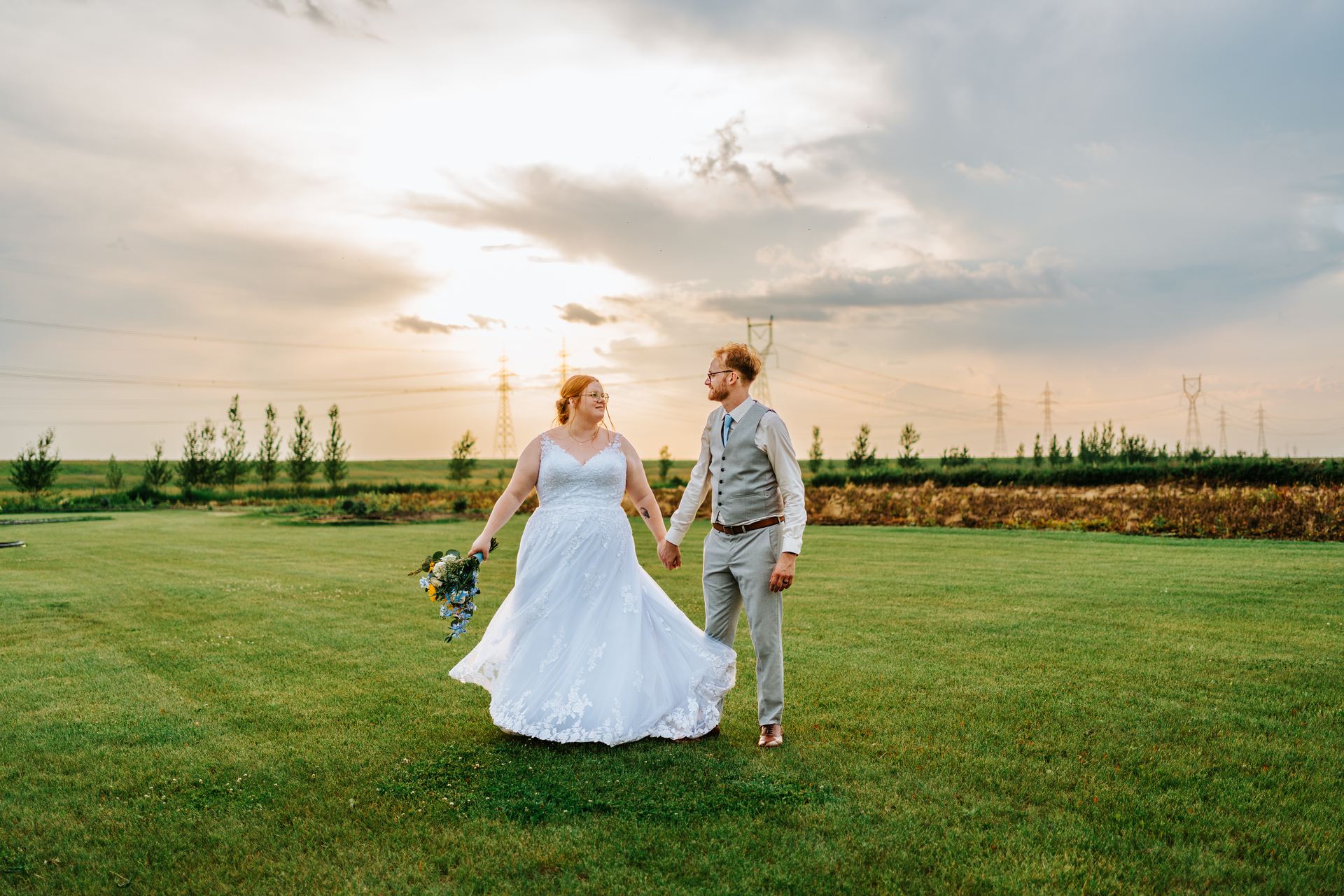 Alysia and Josh walking at golden hour sunset at Deer Meadow Farm Manitoba — wedding photography by Chris Ngo