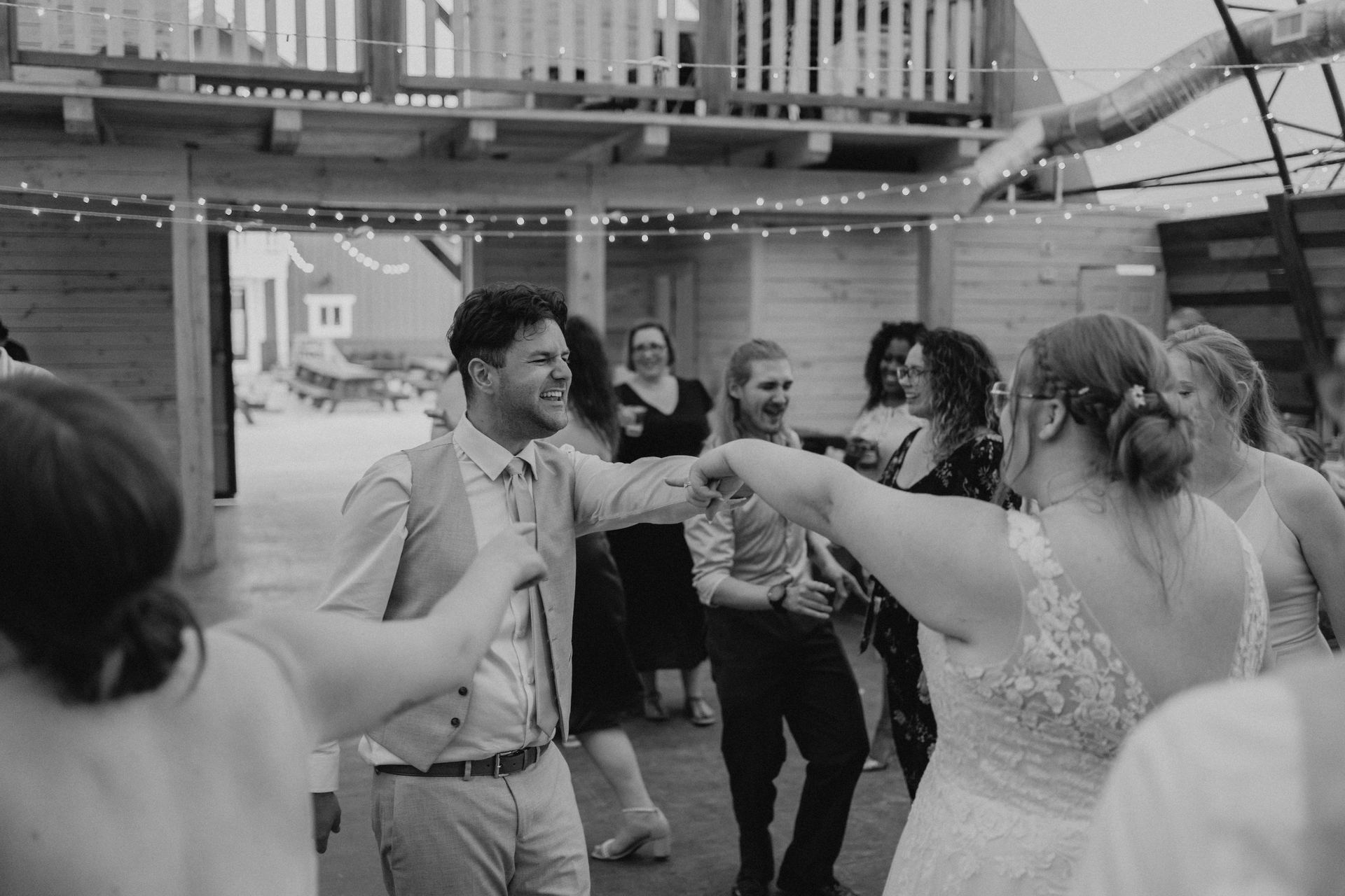 Reception dancing in quonset barn with mezzanine balcony at Deer Meadow Farm Manitoba wedding