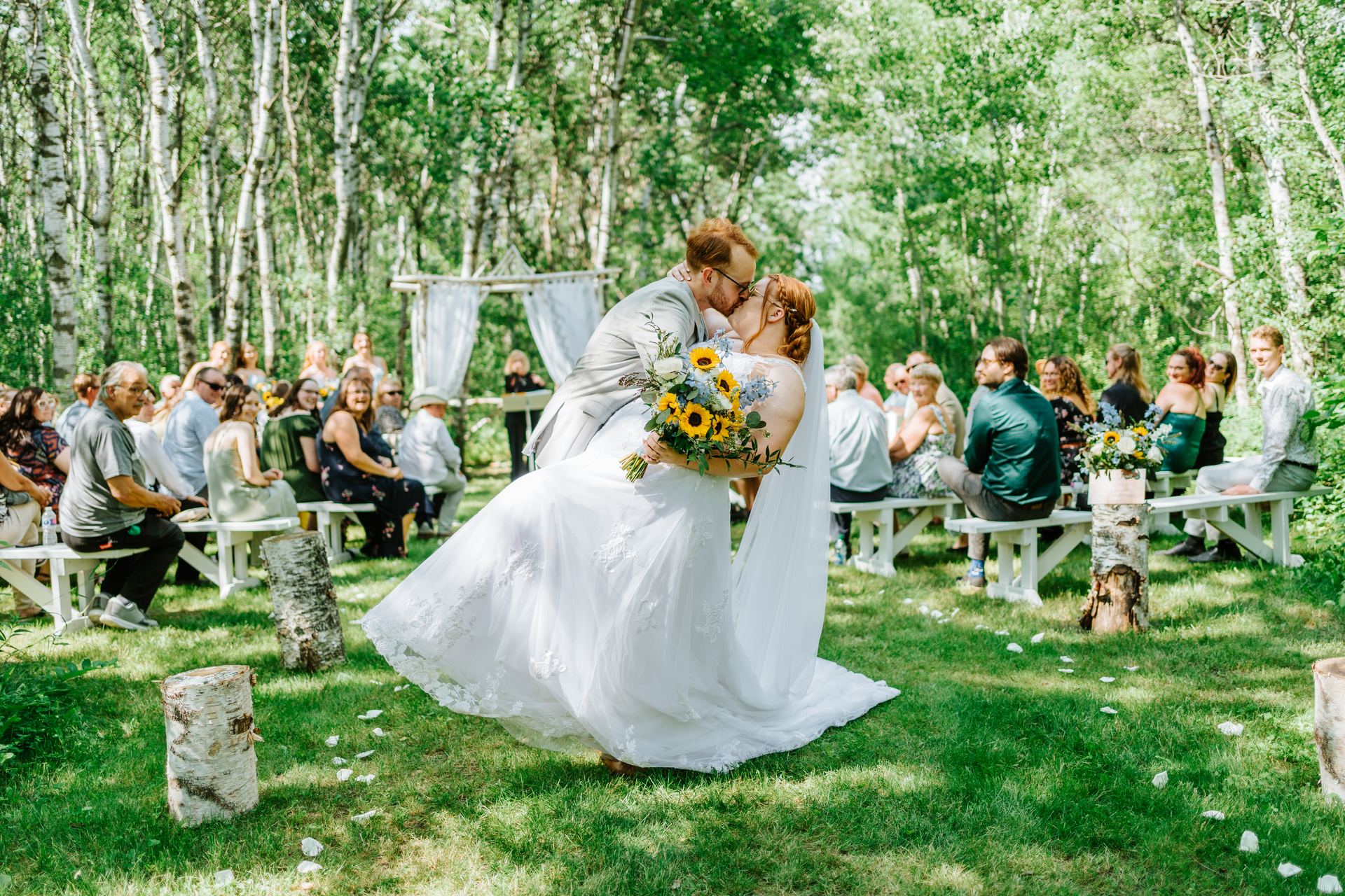 Alysia and Josh just married walking the recessional through the birch forest at Deer Meadow Farm Manitoba