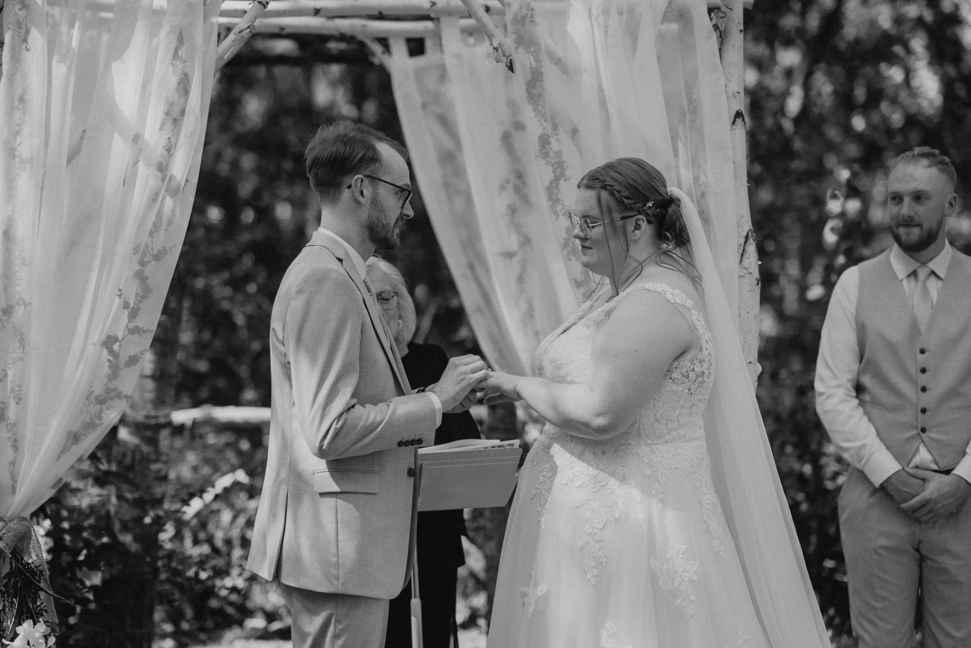 Ring exchange during ceremony at Deer Meadow Farm birch forest wedding in Manitoba