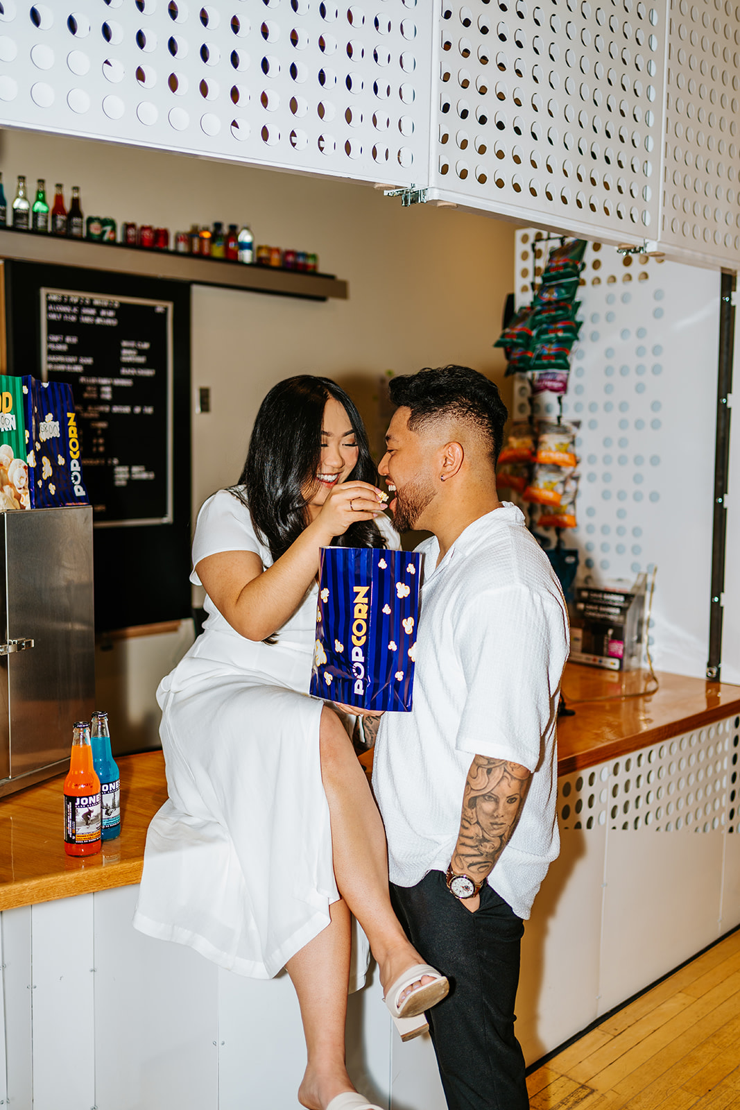 Ayanna and Paul concession stand engagement session theatre Winnipeg — Ngo Photography