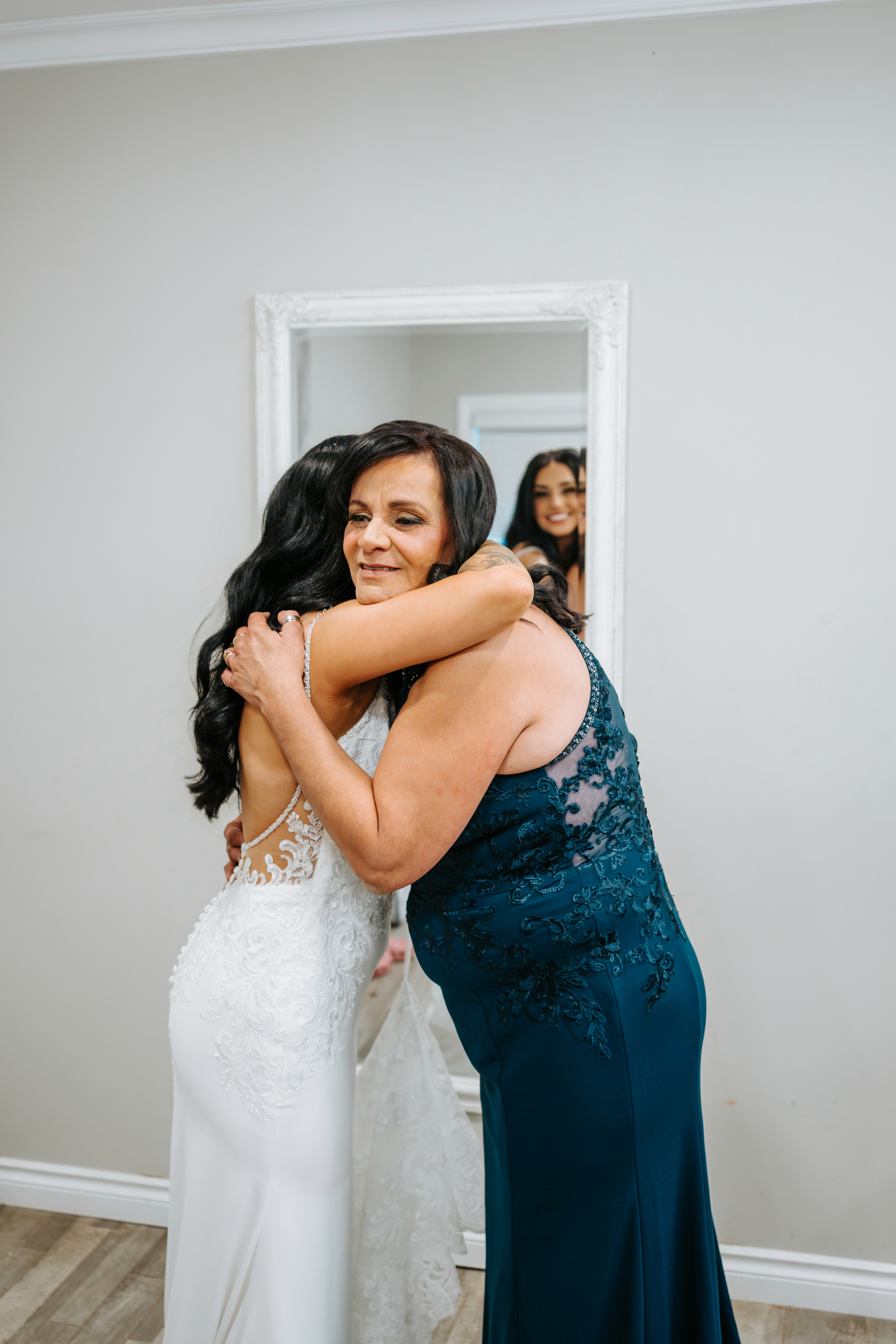 Selena's mother embracing her during getting ready at Ashgrove Acres summer wedding — Ngo Photography Winnipeg