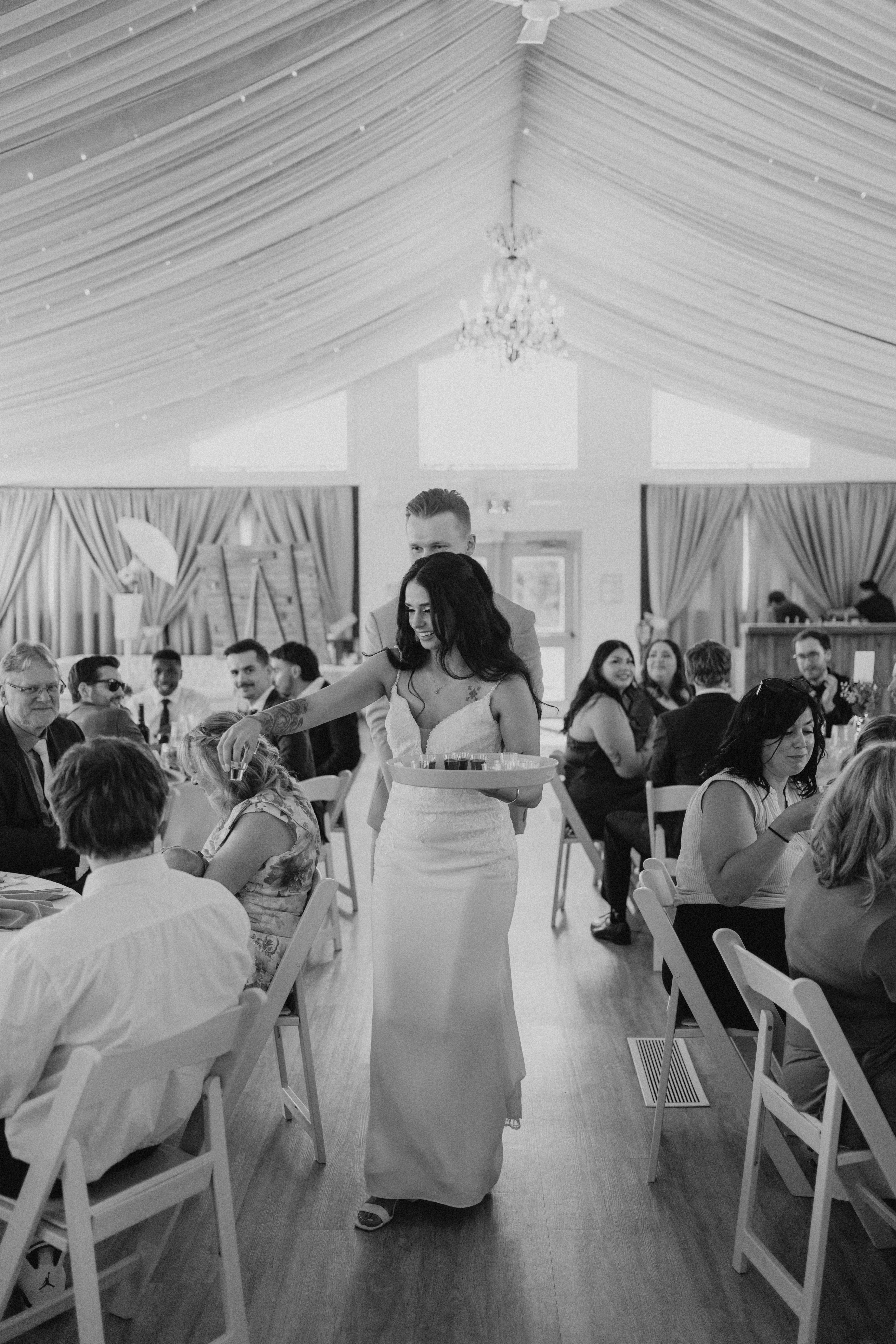 Brandon and Selena grand entrance into the Ashgrove Acres reception tent — showing the draped ceiling and full room of guests — Manitoba wedding photography