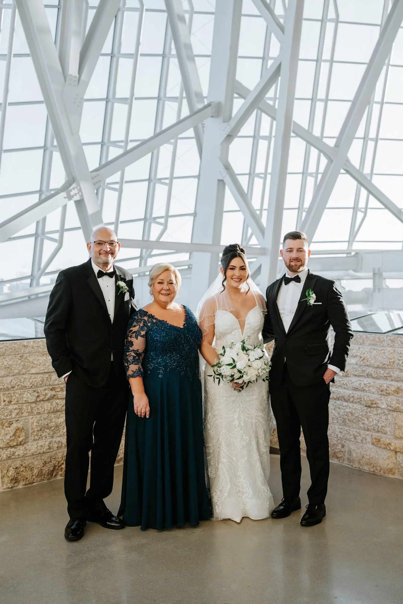 Wedding party portrait with bride, groom and family inside the Canadian Museum for Human Rights — Winnipeg wedding photographer Ngo Photography