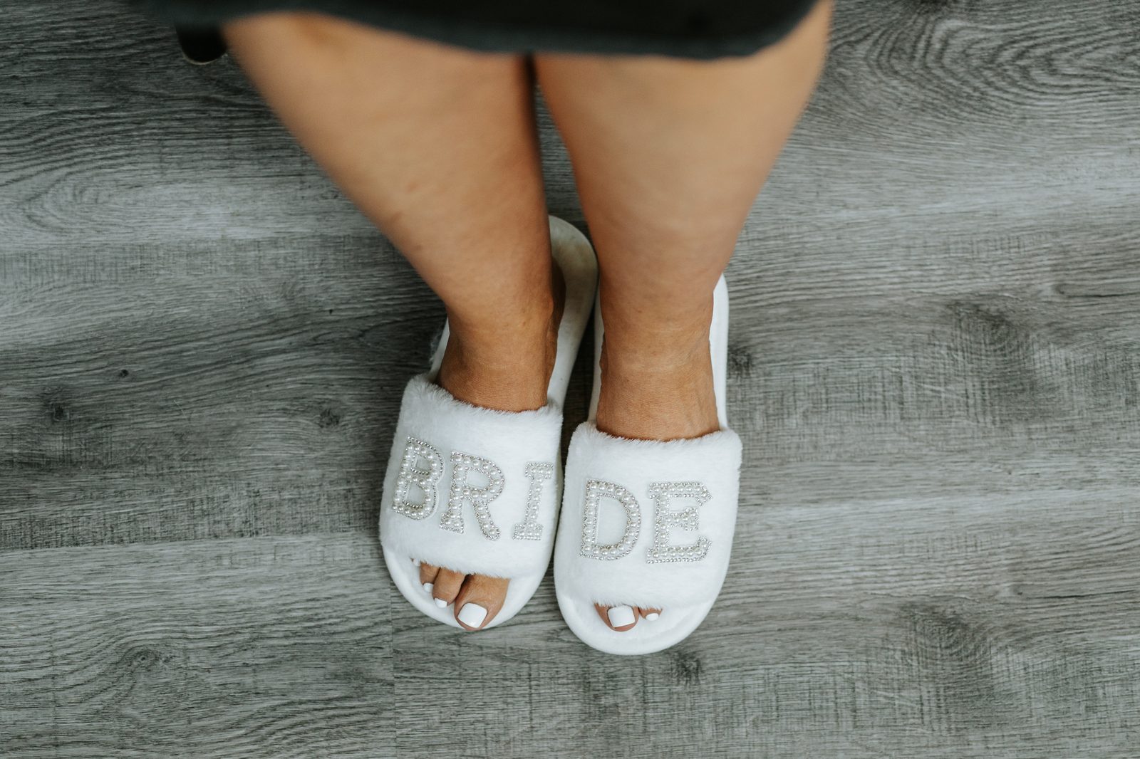 Bride Christina's fuzzy slippers overhead detail shot — Pelican Yacht Club wedding, Ninette, Manitoba
