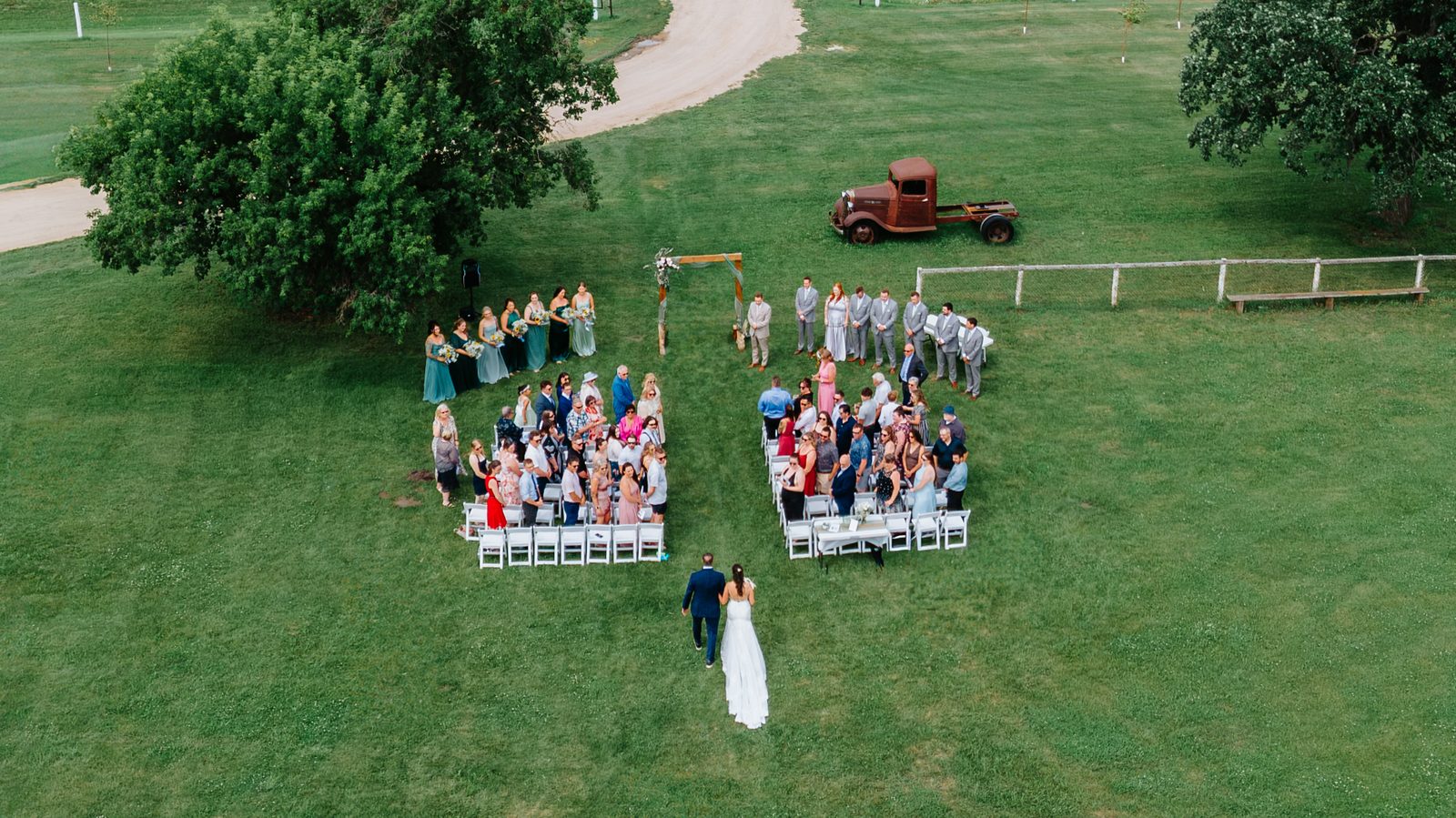 Aerial ceremony photograph at Pelican Yacht Club — drone perspective over the ceremony space and Pelican Lake — Ninette, Manitoba