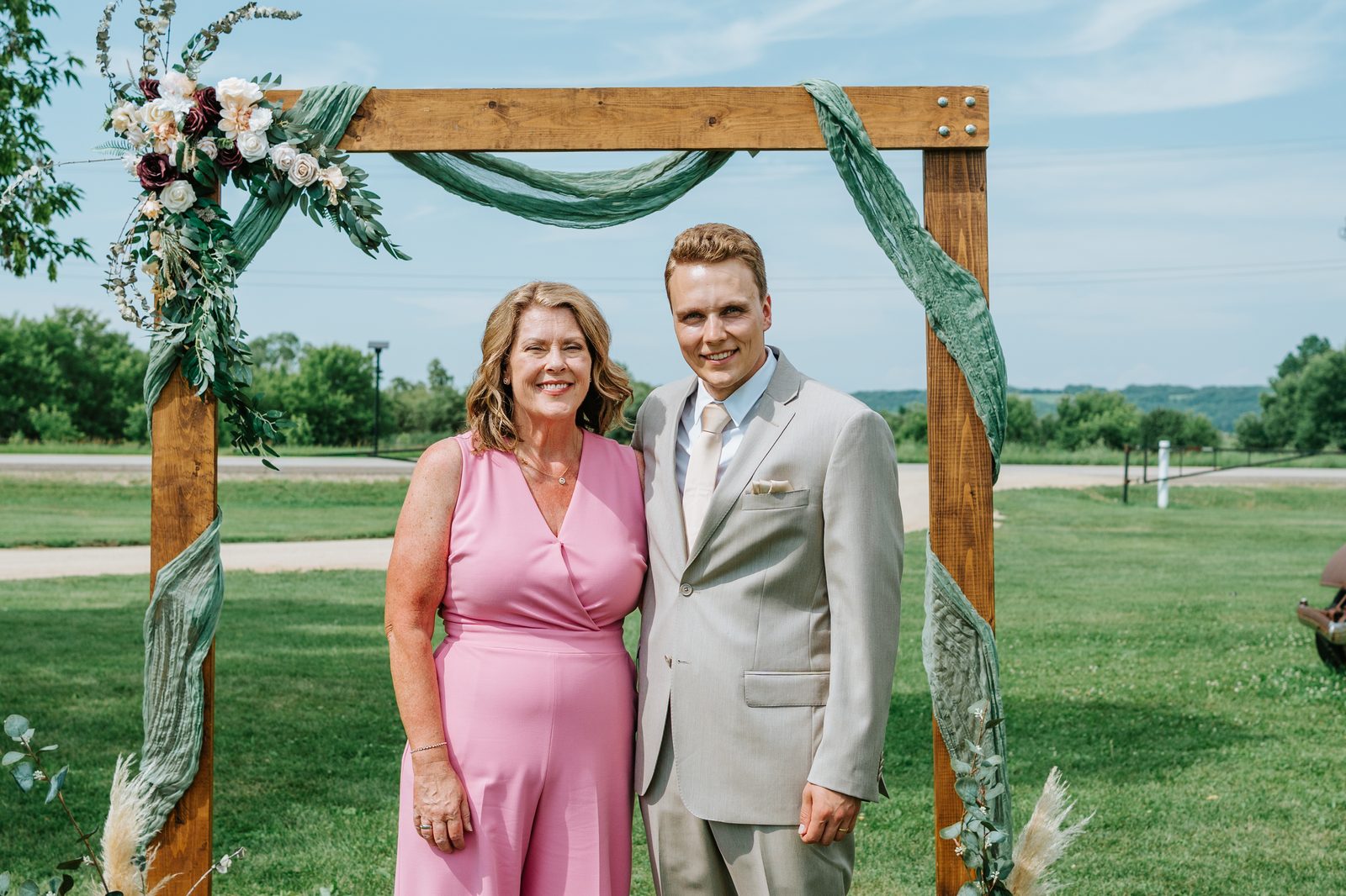 Jack with his mother in pink at the Pelican Yacht Club arbor, Pelican Lake in the background — Ninette, Manitoba