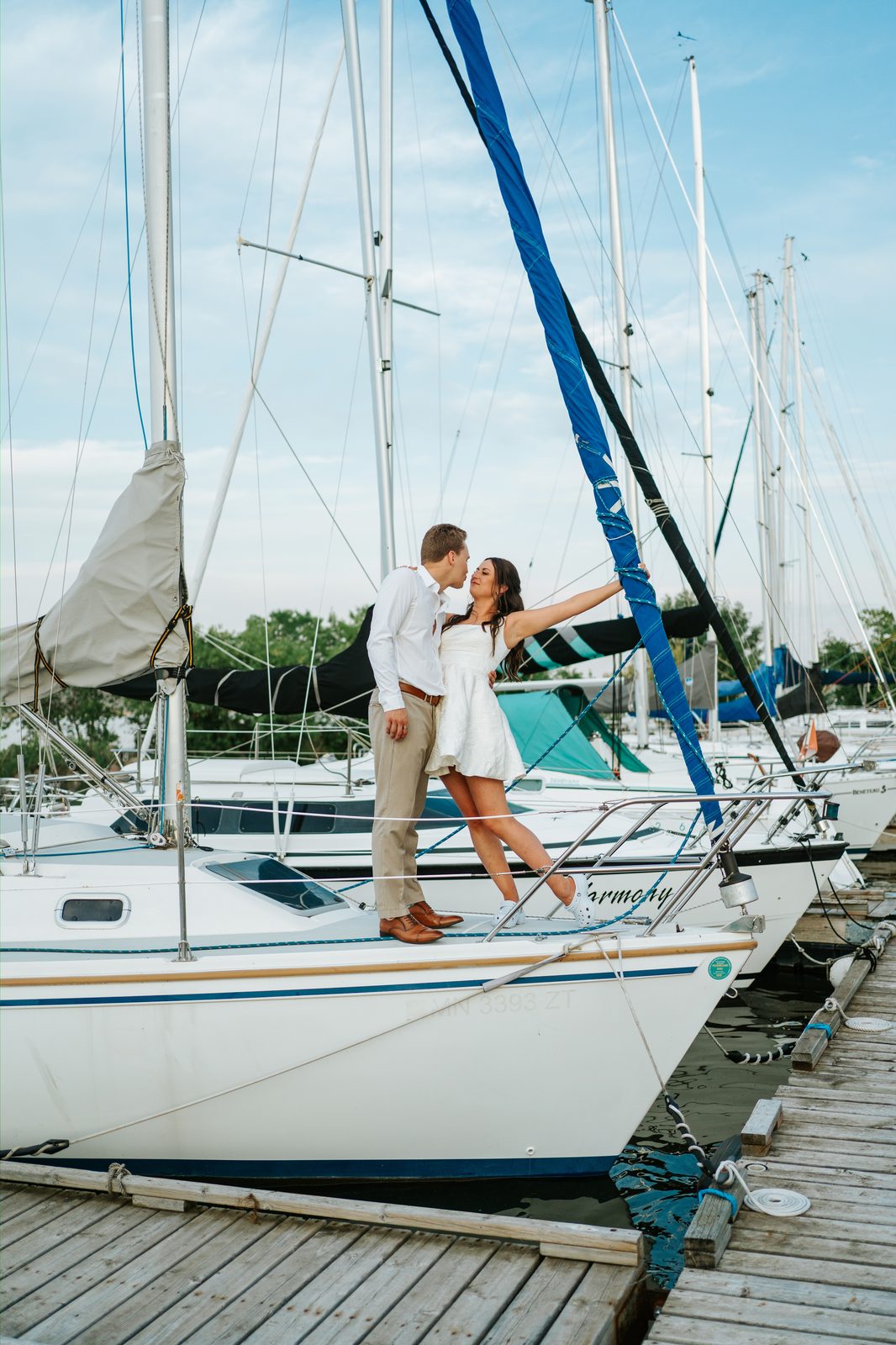 Christina and Jack on the bow of the sailboat Harmony at the Pelican Yacht Club marina — Pelican Lake, Ninette, Manitoba