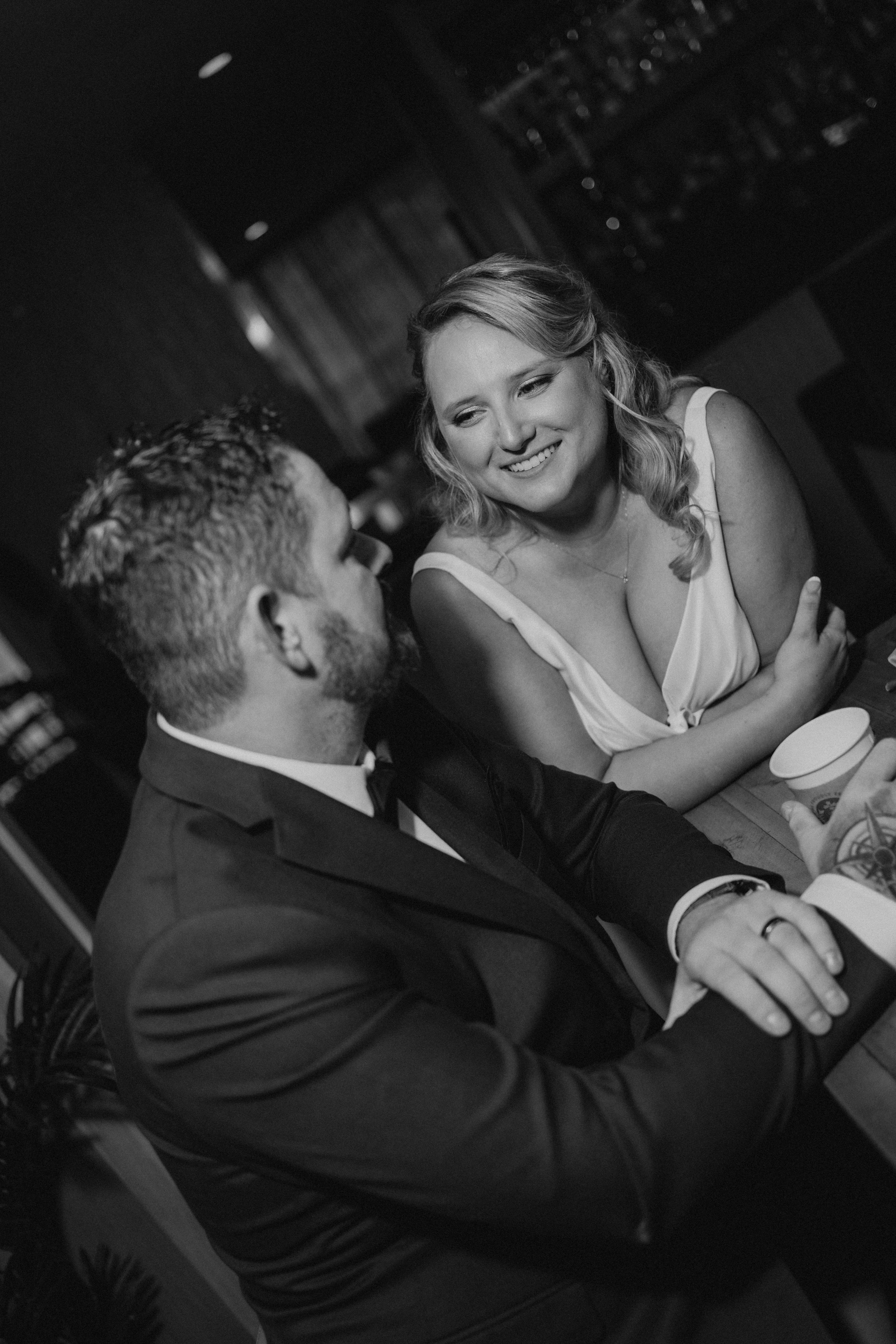 Dave and Bailey sharing a quiet intimate moment at the bar inside Rudy's restaurant before guests arrive — wedding photography by Ngo Photography Winnipeg