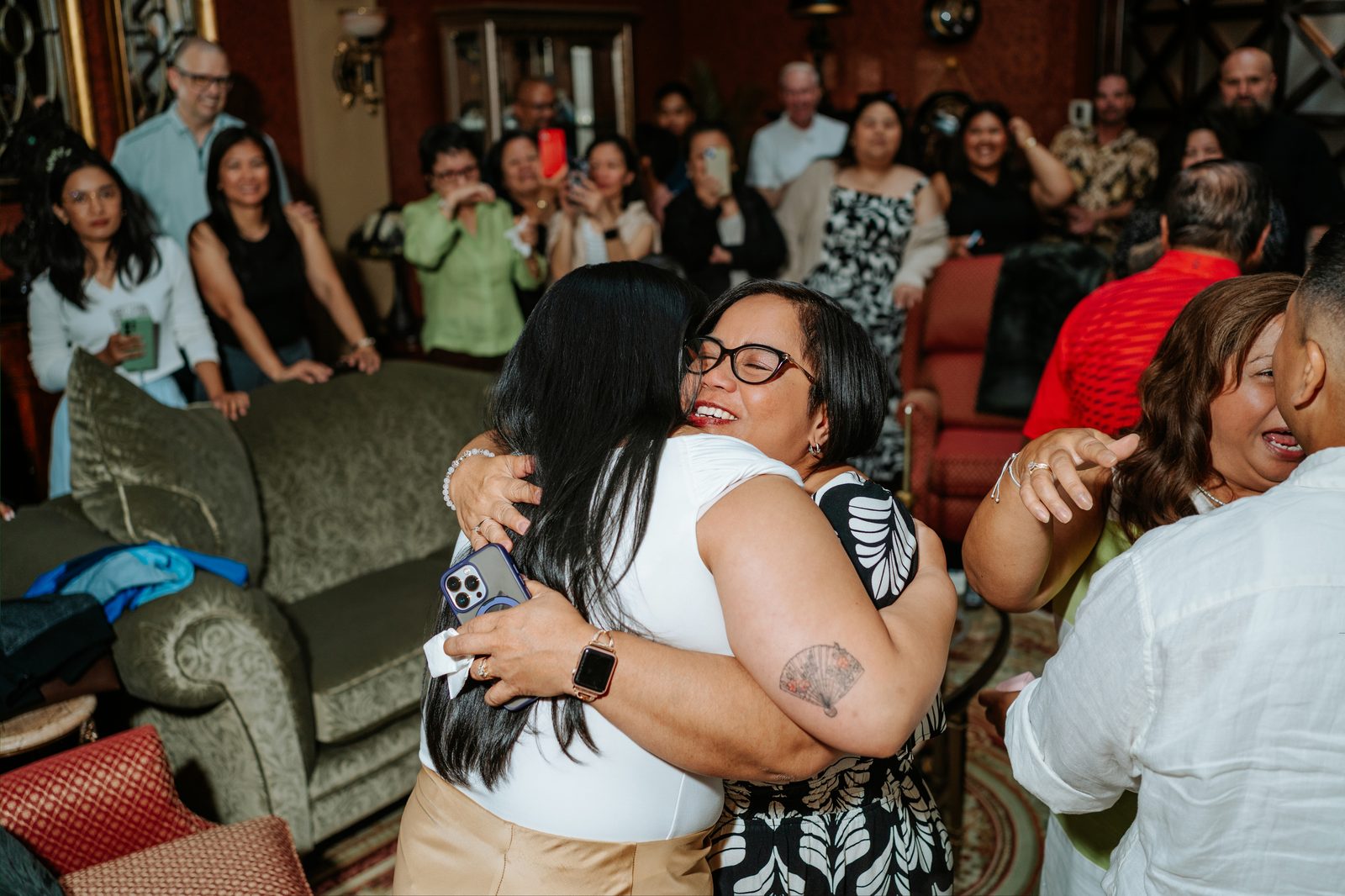 Candid moment of family members reacting to the surprise proposal — surprise proposal photography downtown Winnipeg by Ngo Photography