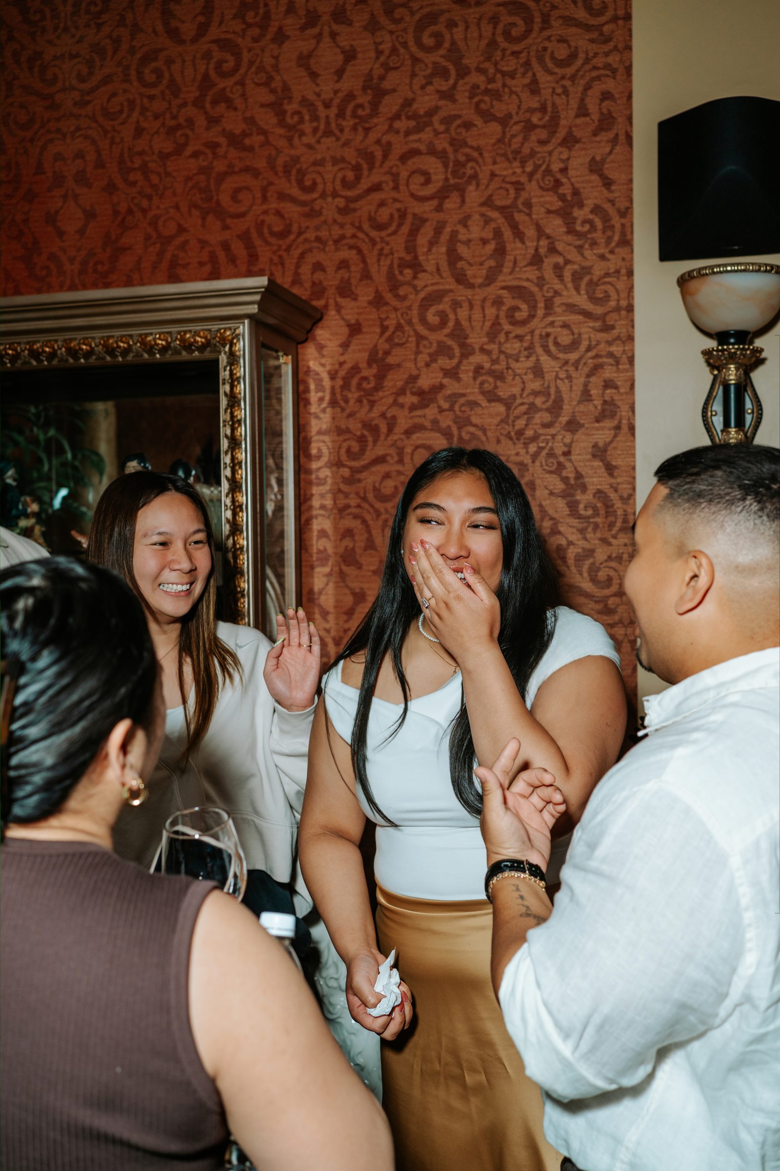 Hugs and tears in the moments after the surprise proposal — black and white candid photography in downtown Winnipeg by Chris Ngo Ngo Photography