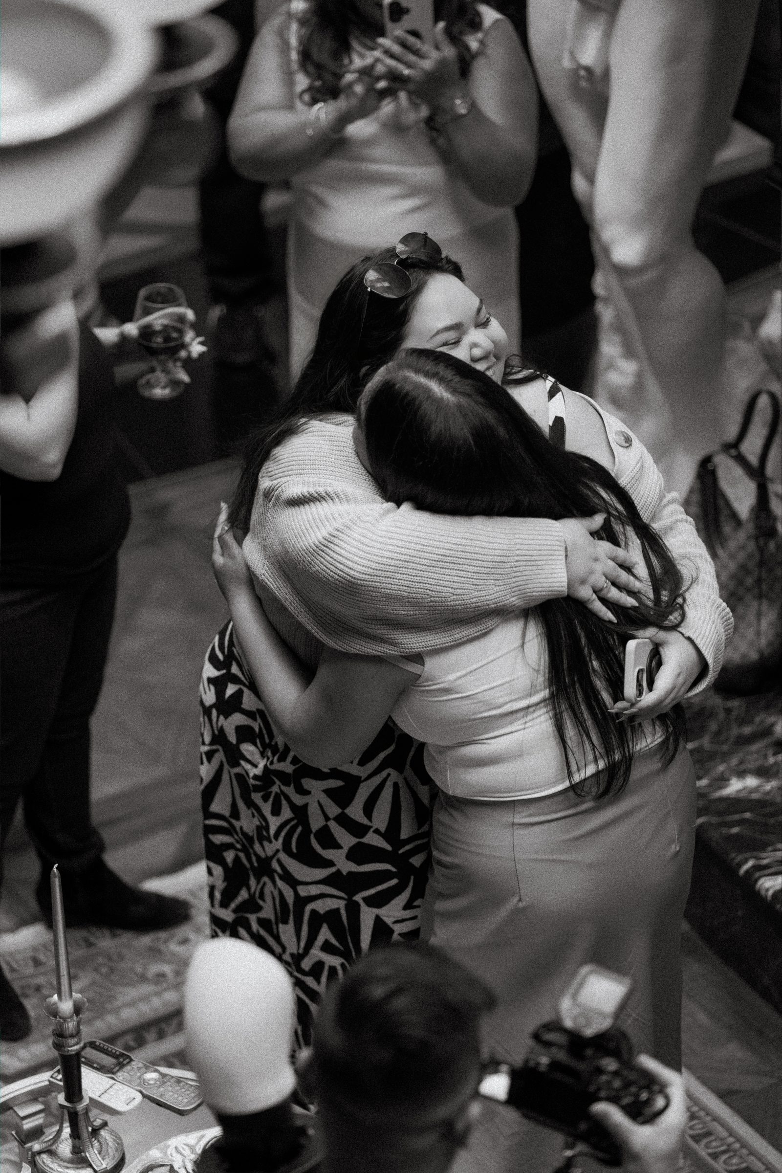 Friends and family gathered inside the historic space after the surprise proposal — candid celebration photography by Chris Ngo downtown Winnipeg