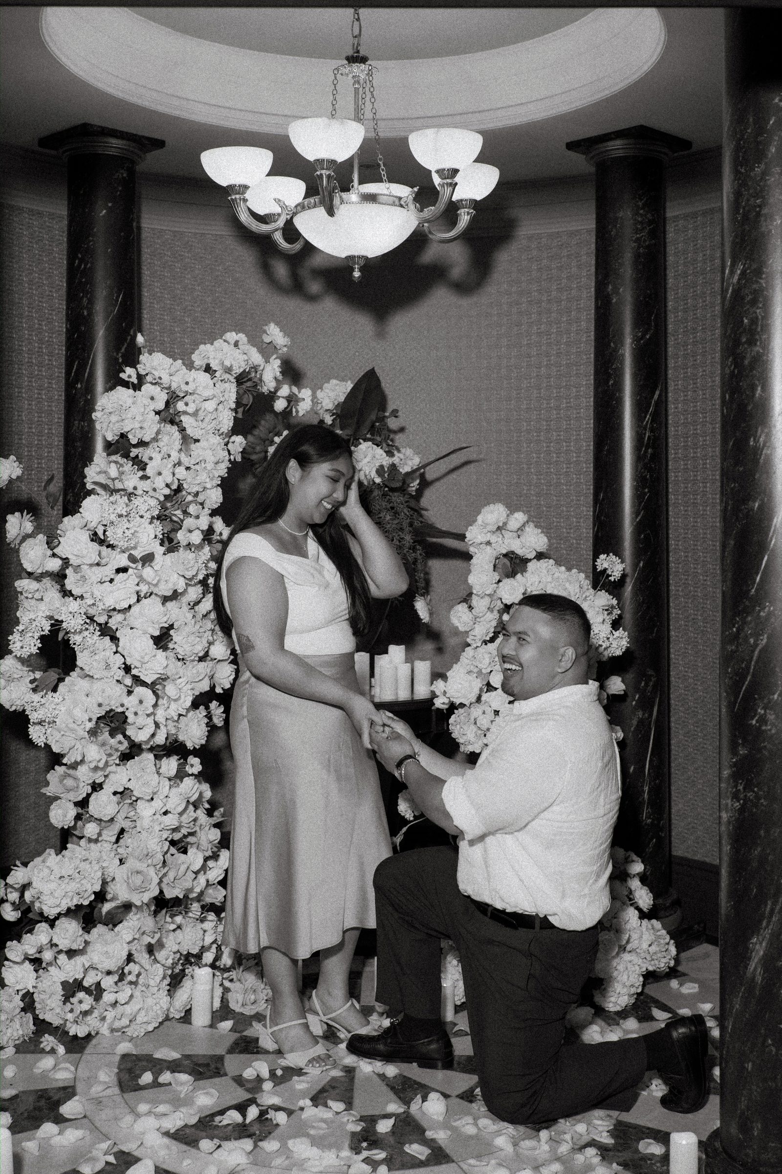 Wide view of the celebration after the surprise proposal — candid documentary photography inside a private historic space downtown Winnipeg by Ngo Photography