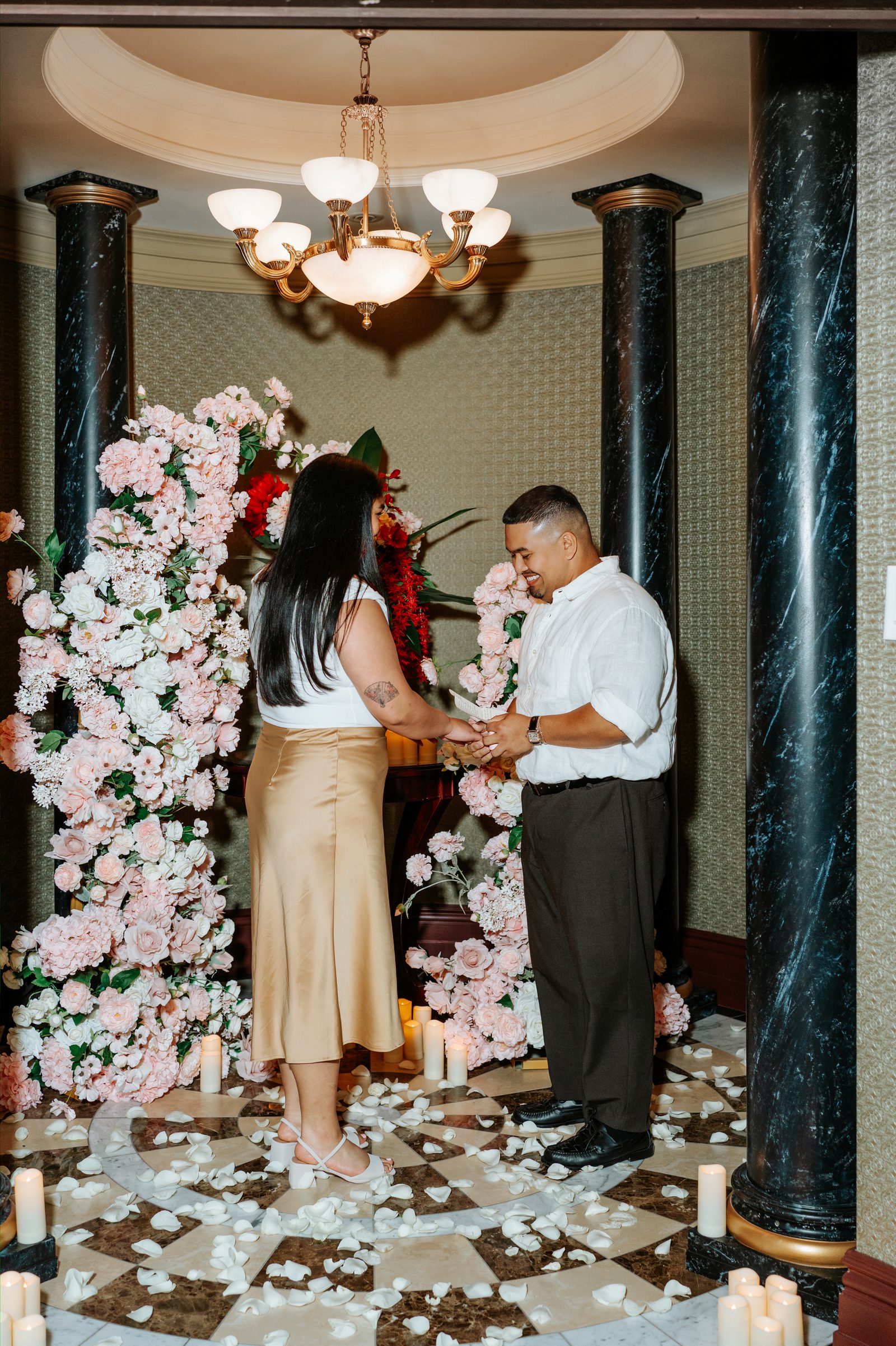 Deril and Annie embracing after the proposal — she said yes — surprise proposal photography in a private historic space in downtown Winnipeg by Chris Ngo