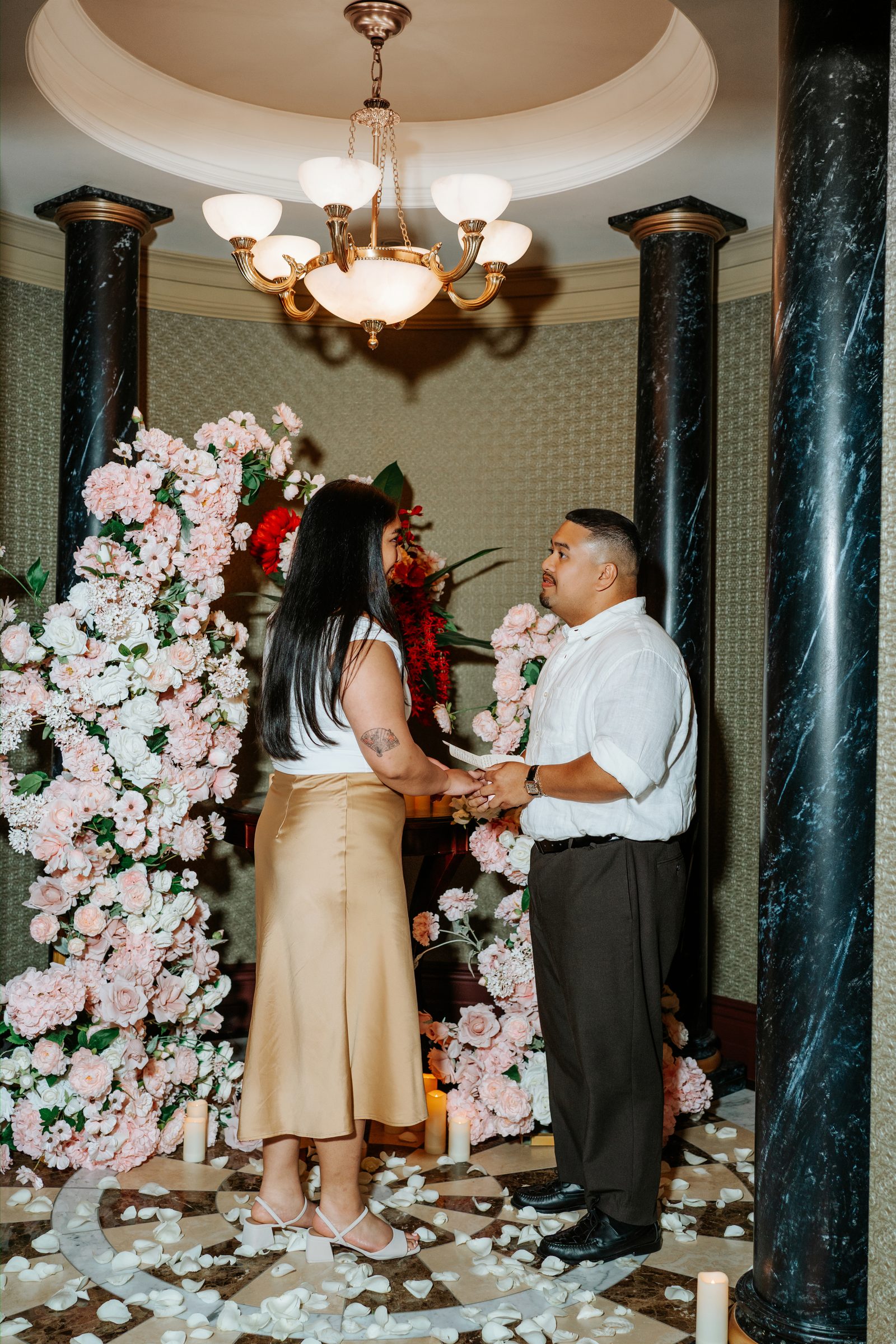 Close portrait of Annie and Deril after the proposal — the ring, the flowers, the candles behind them — surprise proposal photography Winnipeg