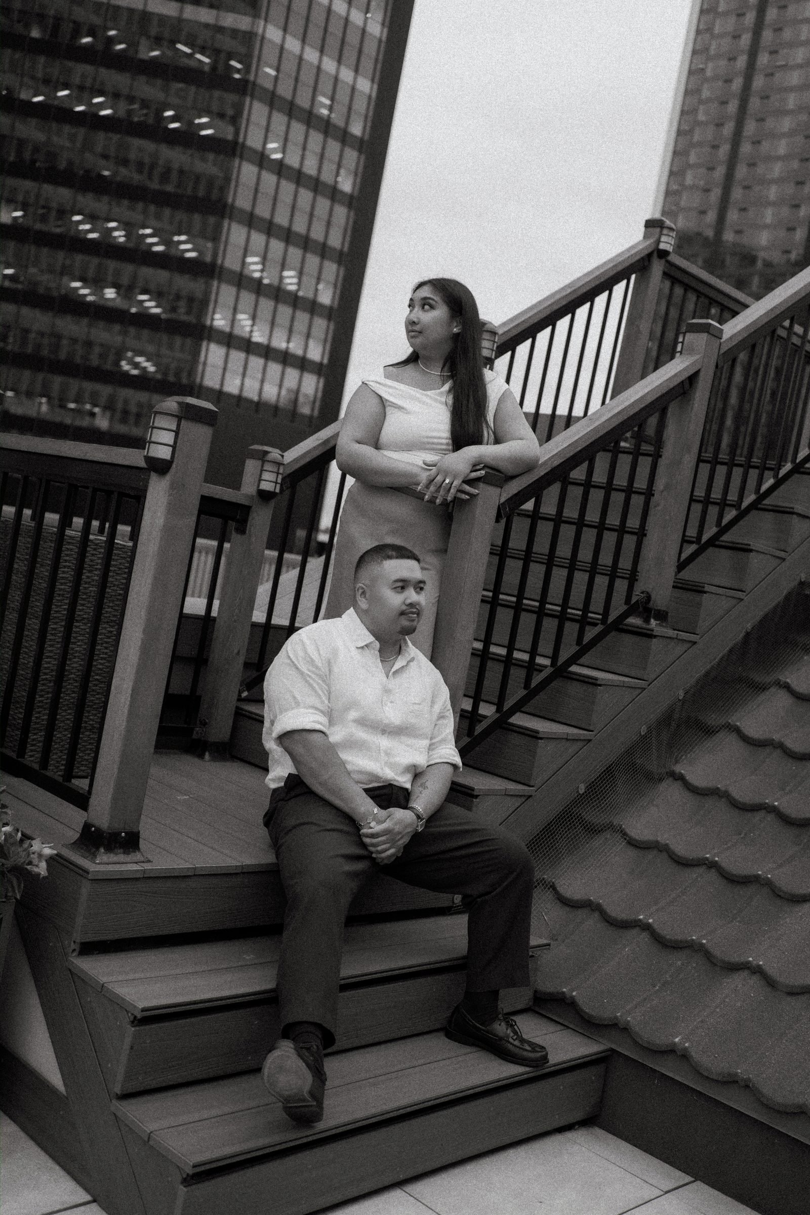 Deril and Annie close portrait on the rooftop above the Winnipeg skyline — surprise proposal photographer Chris Ngo