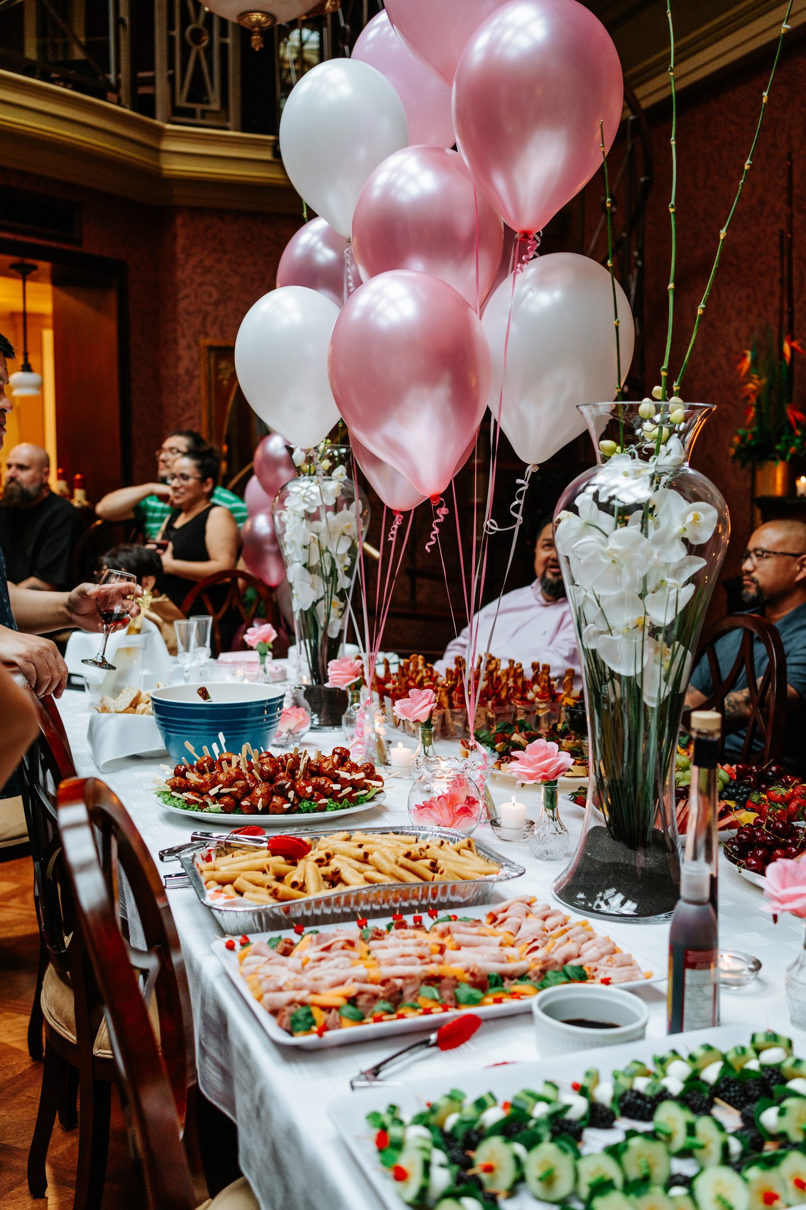 Pillar candles arranged across the marble rotunda floor surrounded by white rose petals — surprise proposal setup in downtown Winnipeg by Ngo Photography