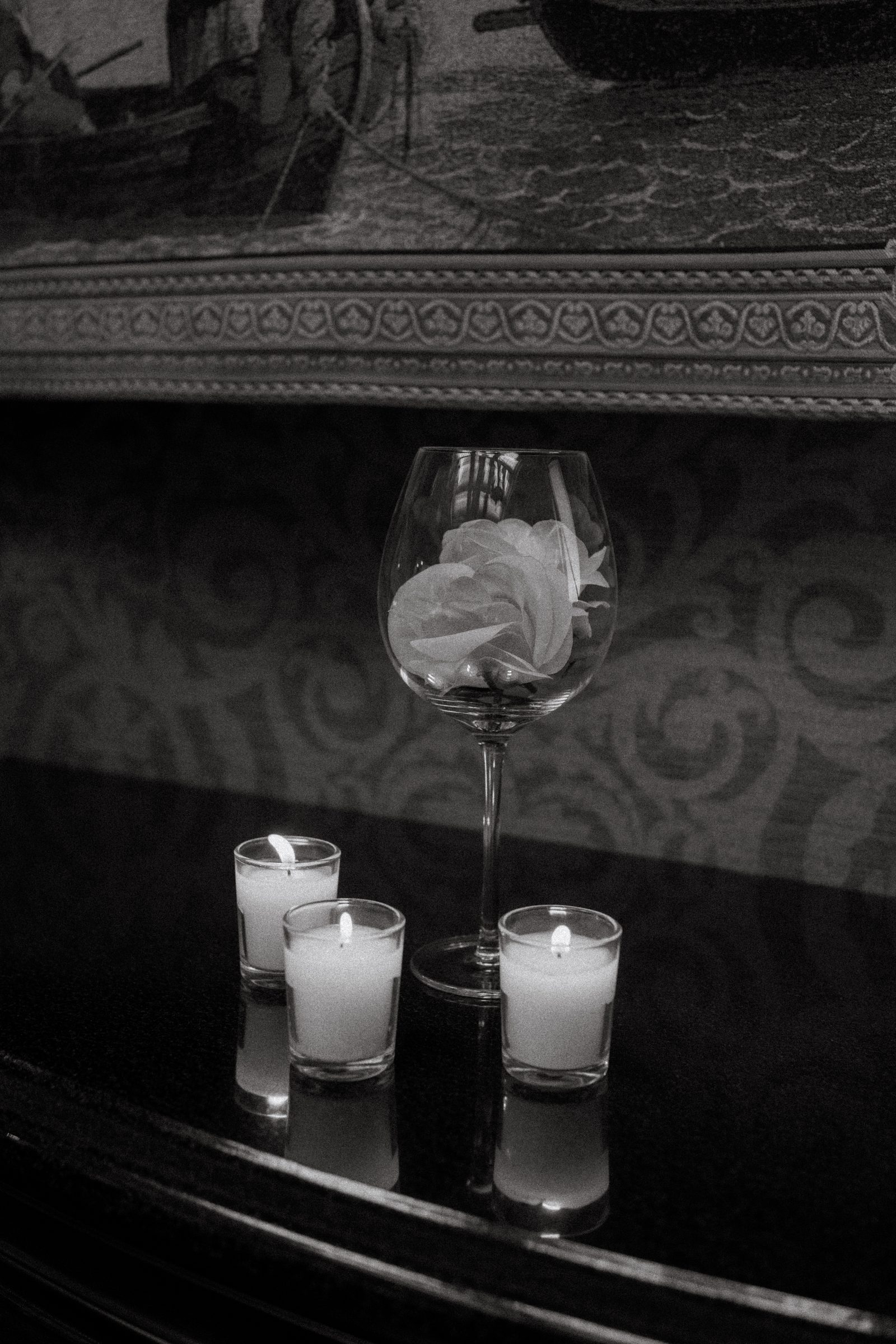 Close detail of blush rose arch with candles and petals on the marble floor — surprise proposal setup downtown Winnipeg Ngo Photography