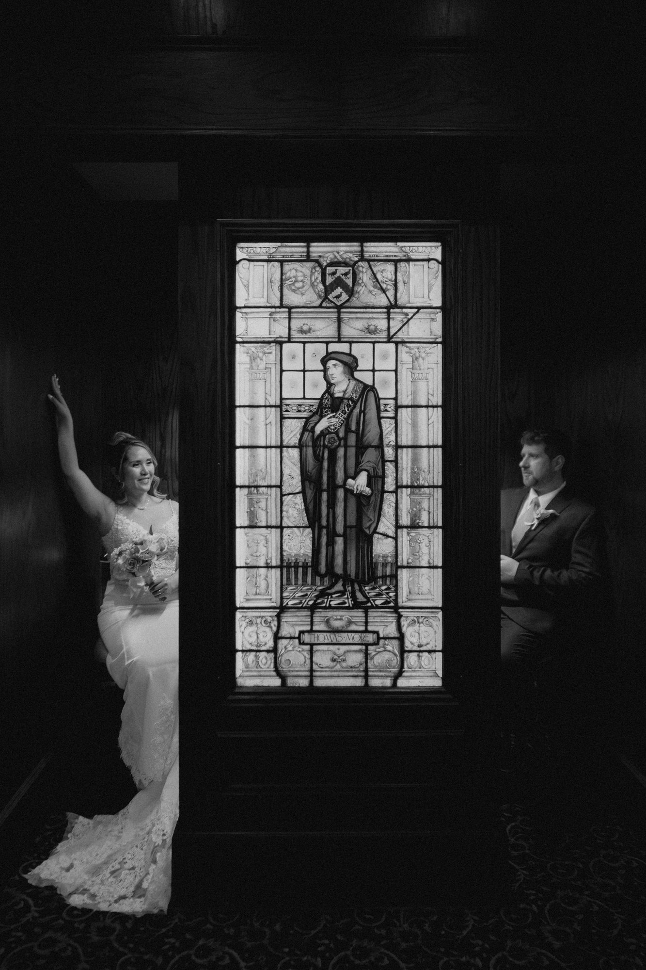 Eden and Justin black and white portrait with stained glass at Bailey's Restaurant Winnipeg — Ngo Photography
