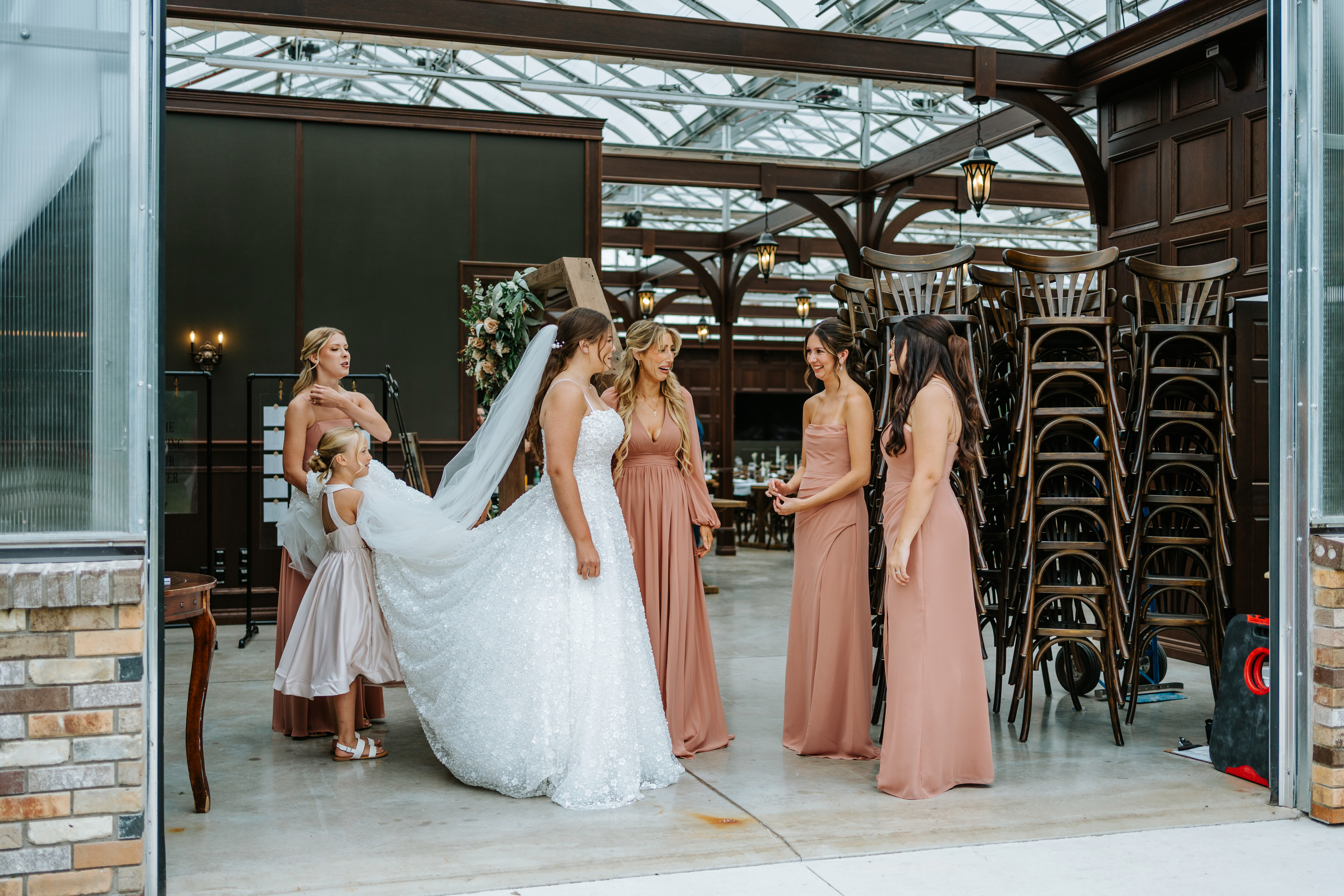 Erin in her sparkle ballgown with her bridesmaids in the entrance of the Buttercup Café greenhouse conservatory — wedding party photography by Chris Ngo