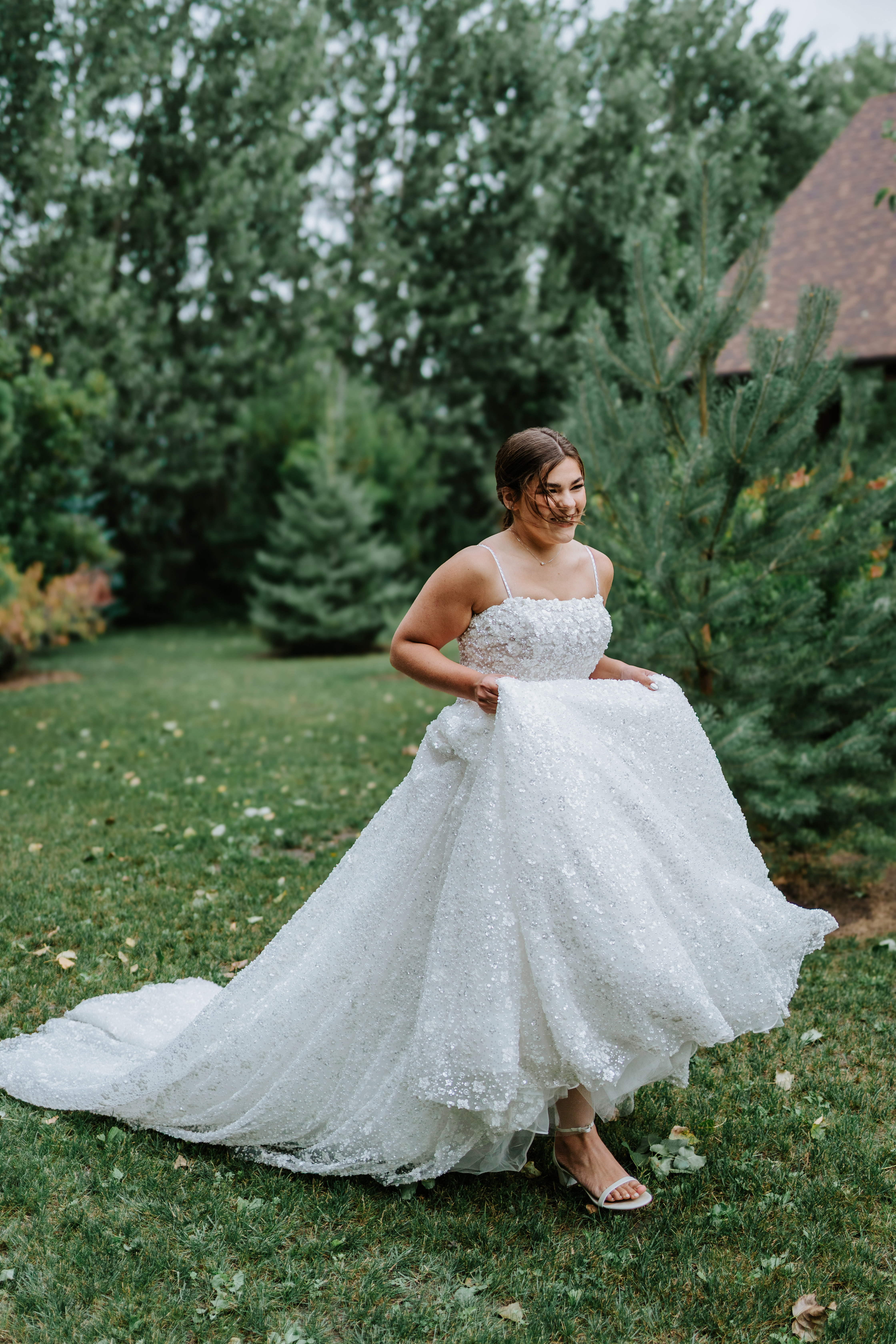 Erin twirling in her full sparkle ballgown in the gardens at Buttercup Café Manitoba — bridal portrait by Ngo Photography Winnipeg