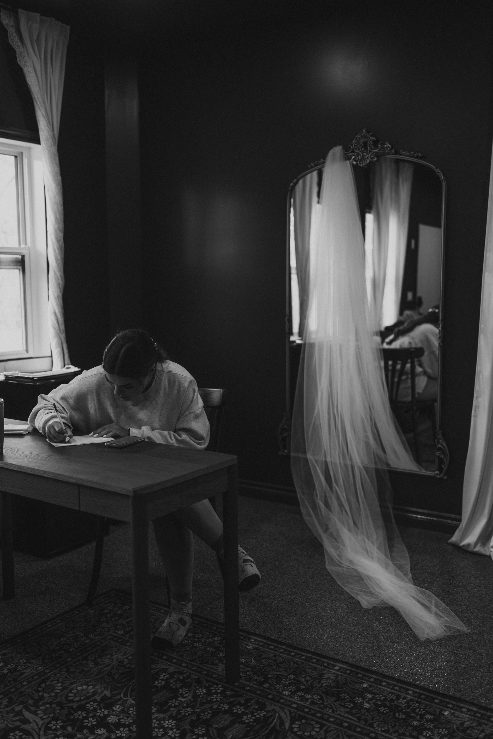 Erin writing her vows on her wedding morning with her veil hanging beside an antique mirror — Buttercup Café wedding photography by Chris Ngo