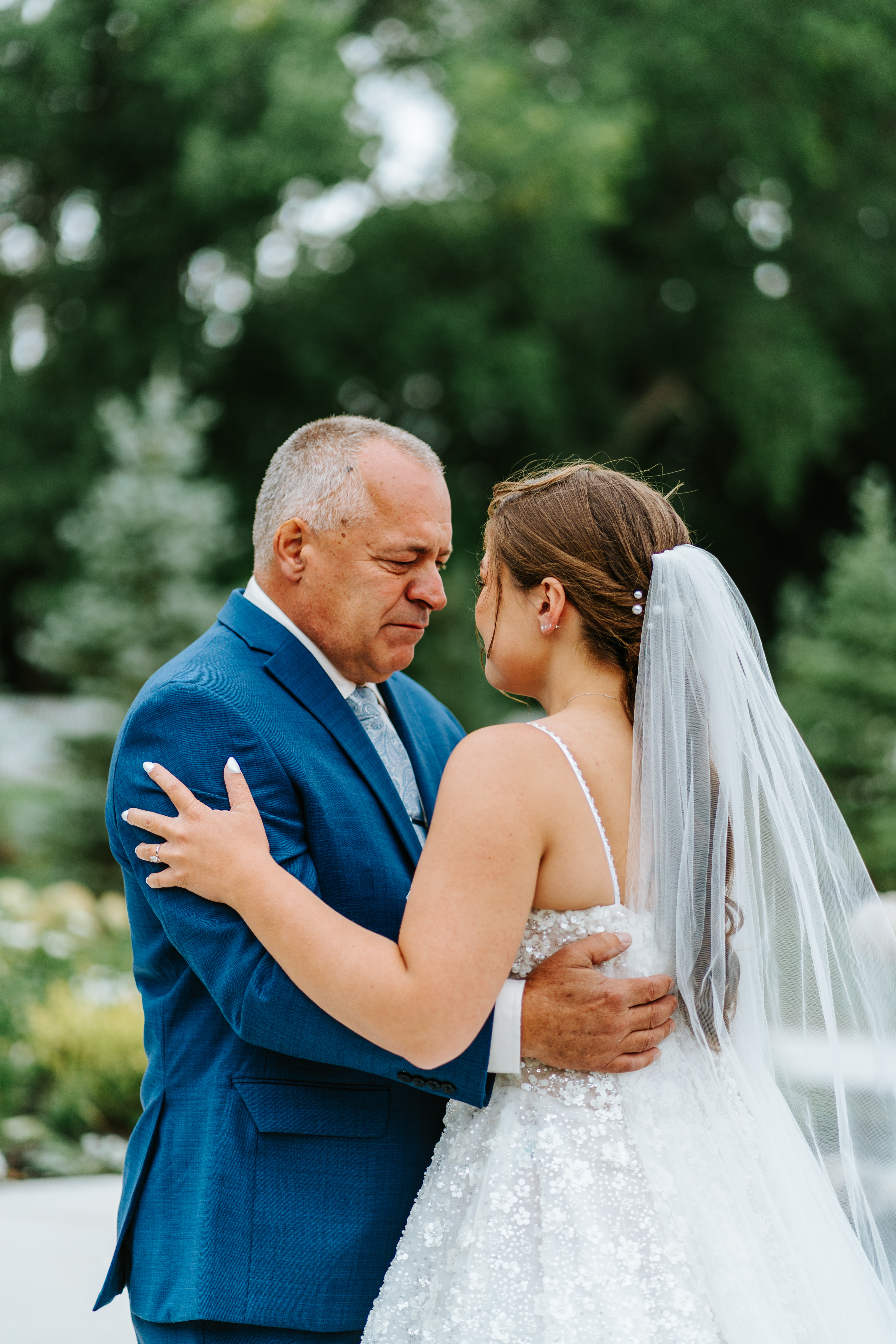 Erin's father holding her close after seeing her for the first time on her wedding day at Buttercup Café — emotional first look photography by Ngo Photography
