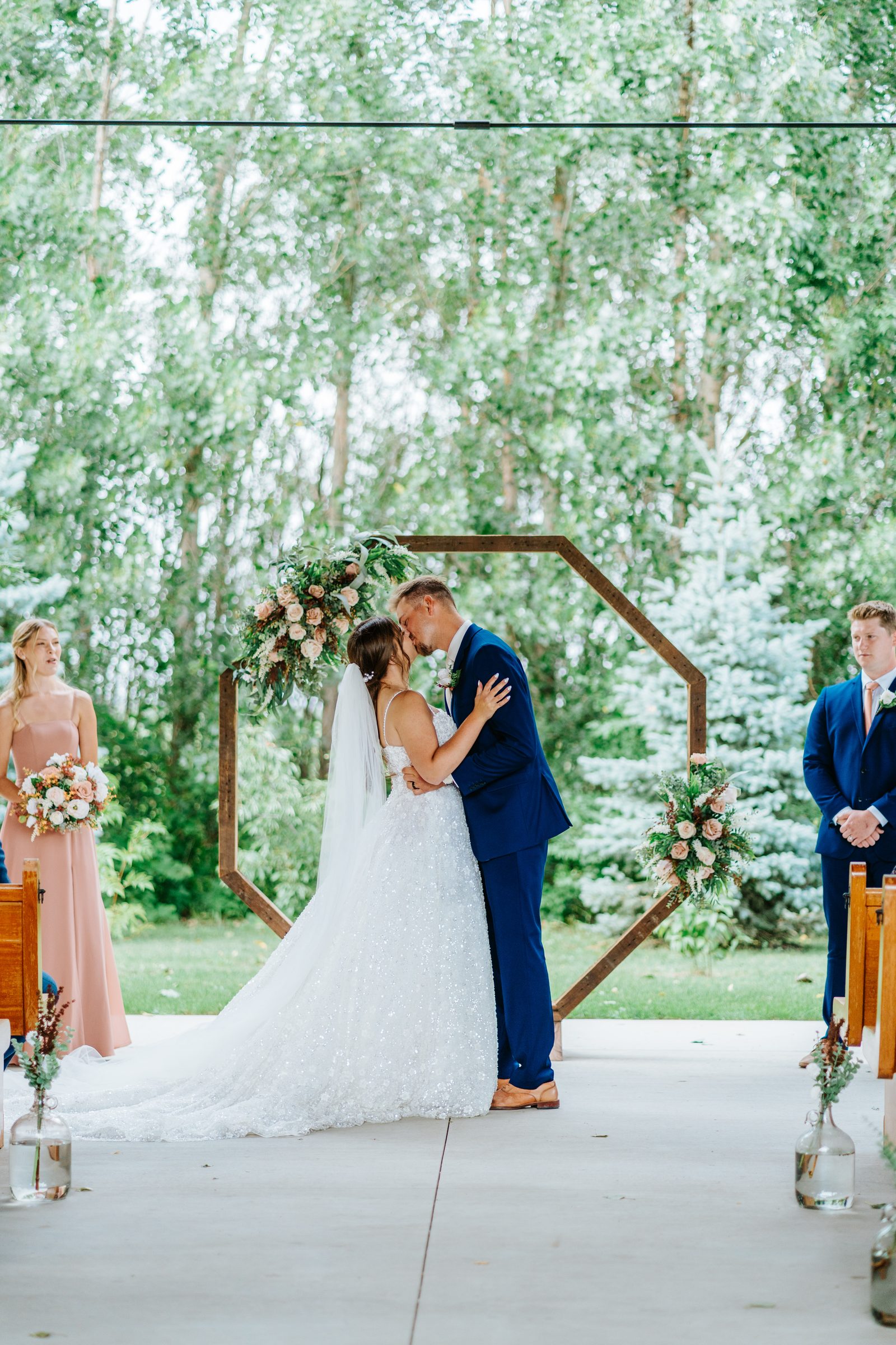First kiss ceremony at Buttercup Café outdoor pavilion arch Winnipeg — Ngo Photography