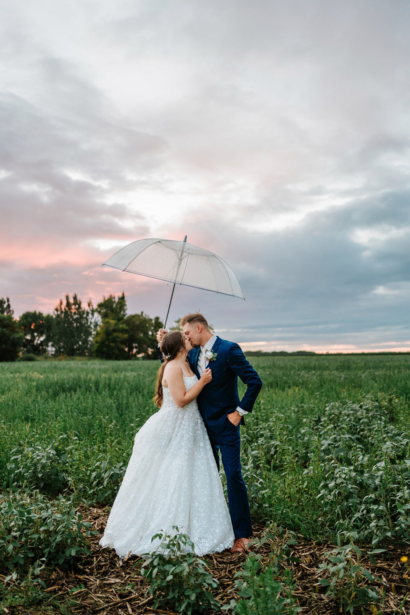 Erin and Jayden kissing under a bubble umbrella at golden hour — Ngo Photography