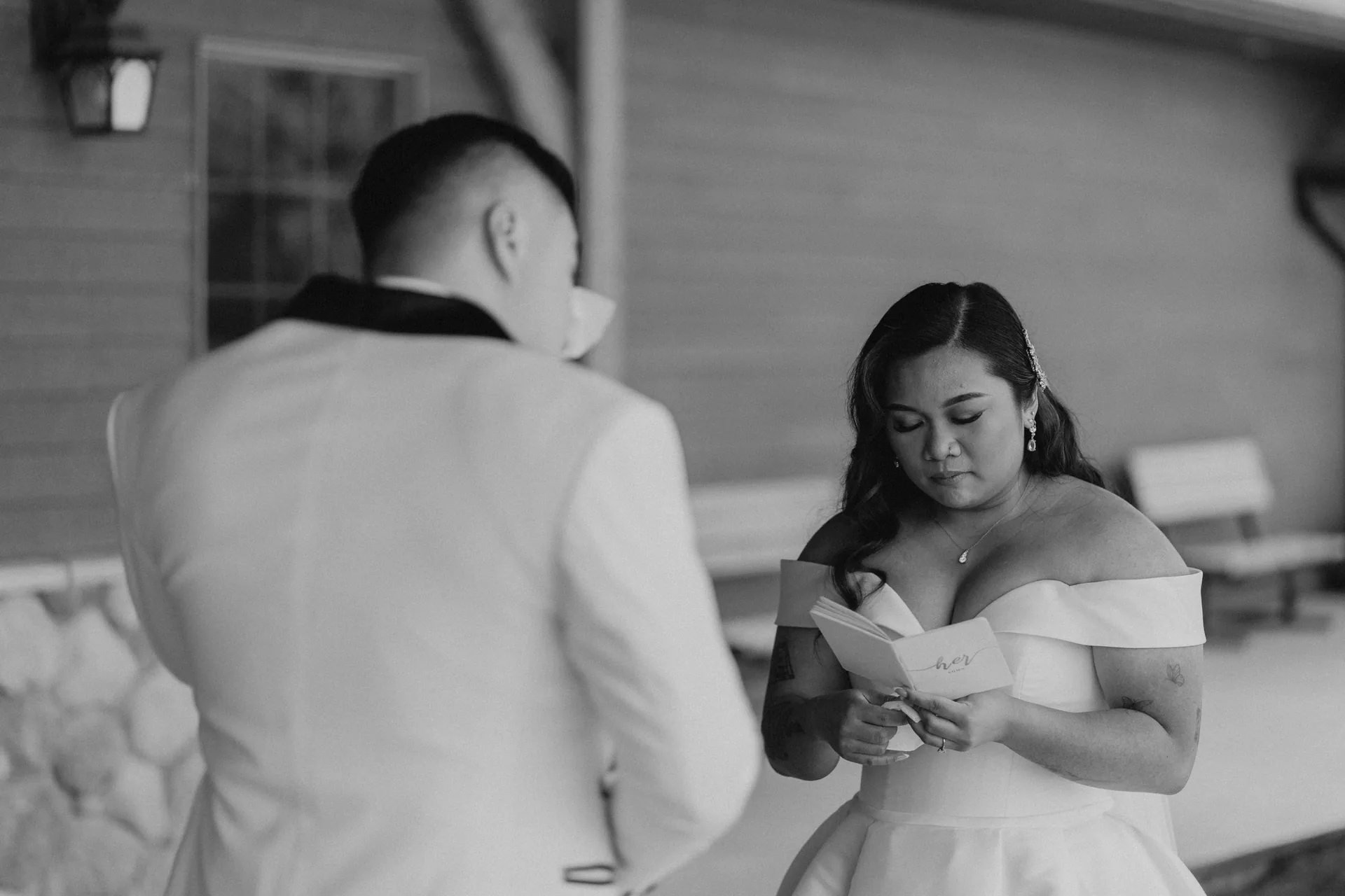 Bride arms outstretched during recessional at Bridges Golf Course, black and white — Winnipeg