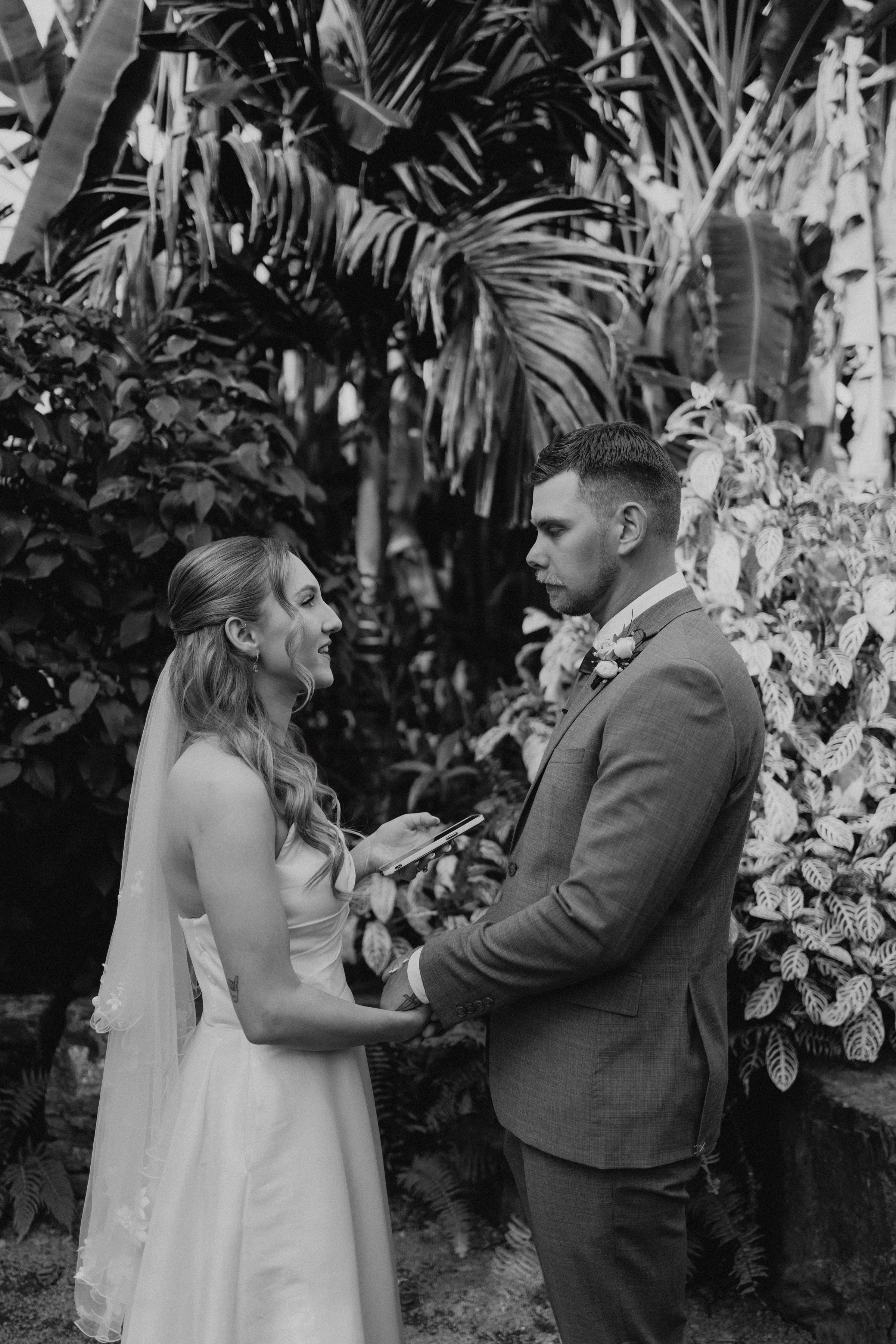 Couple holding hands during wedding vows — ceremony photography Winnipeg