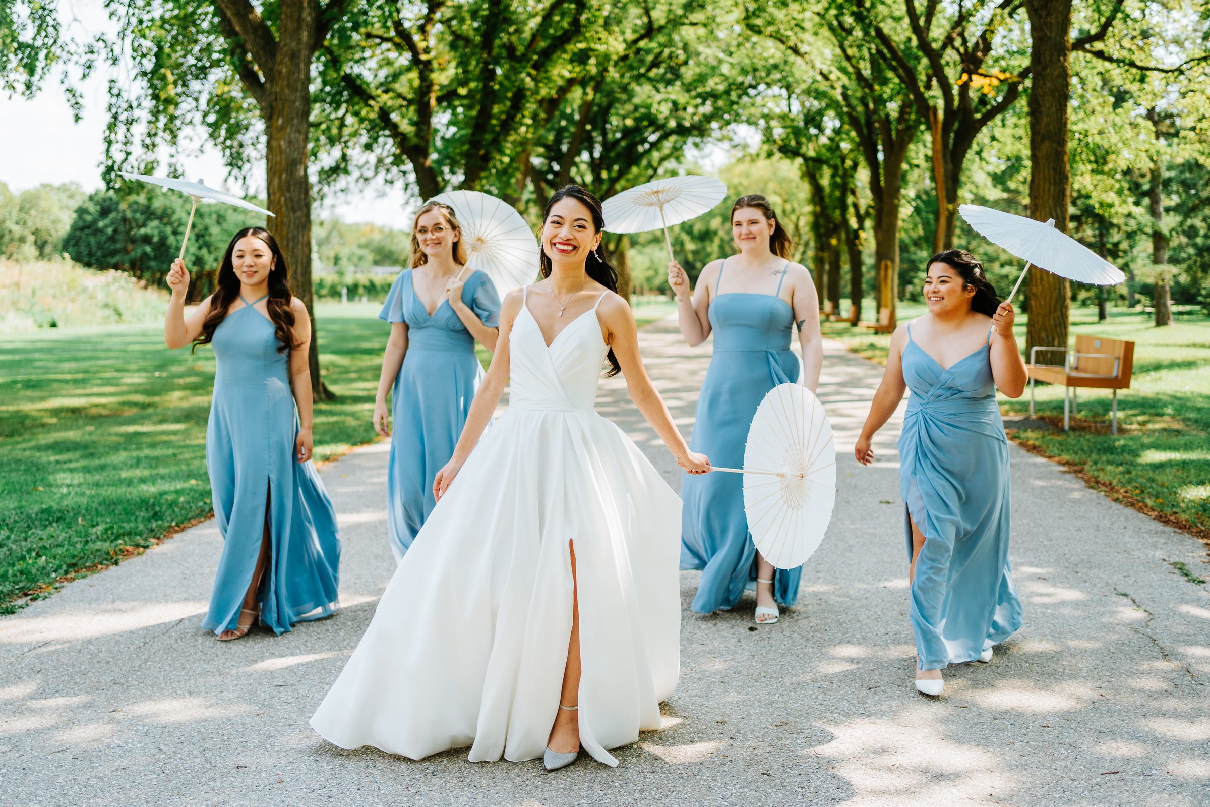 Bride and bridesmaids with parasols at Assiniboine Park Winnipeg — Ngo Photography
