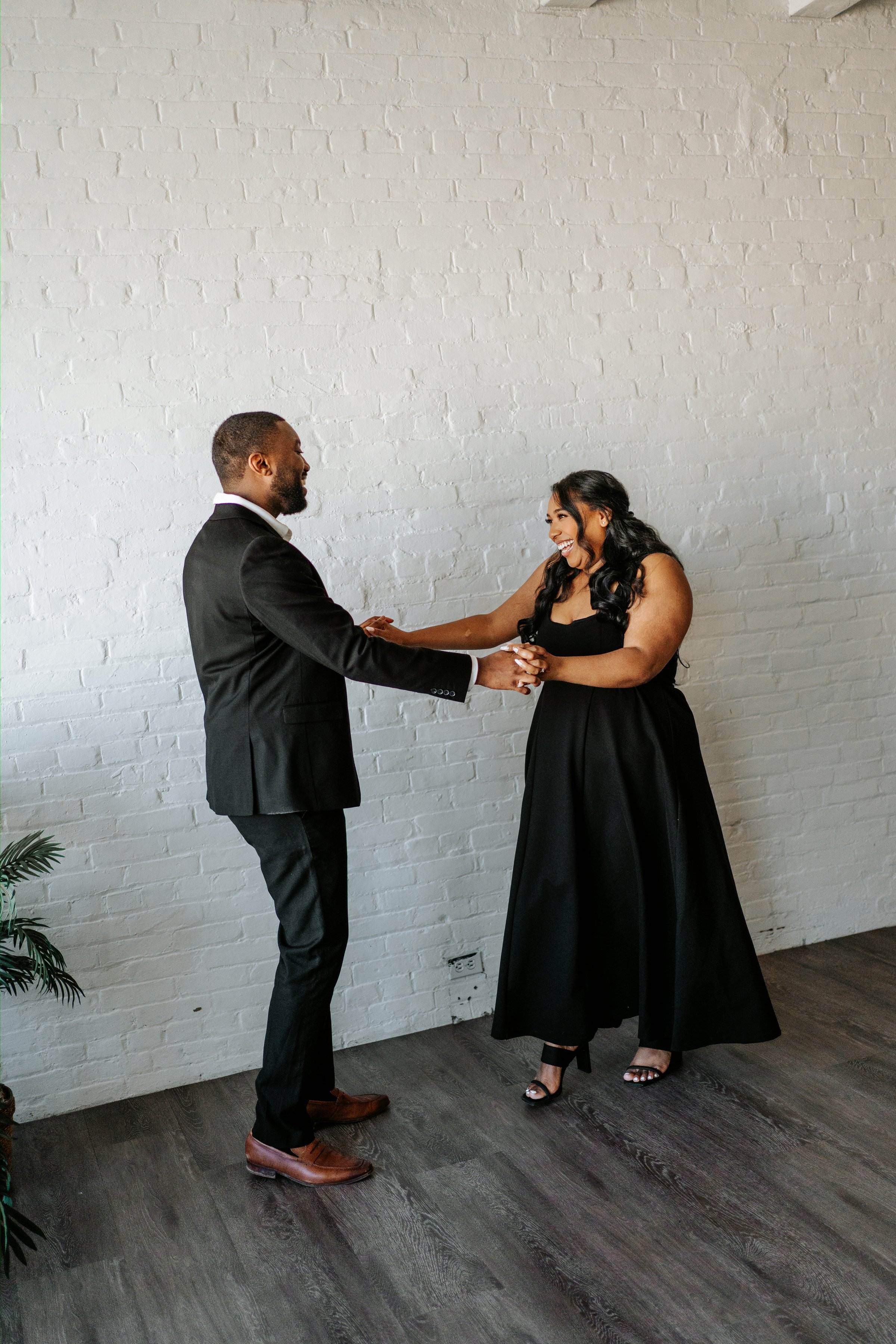 Jaida and Jordan walking through a downtown Winnipeg street during their engagement session — photography by Chris Ngo, Ngo Photography