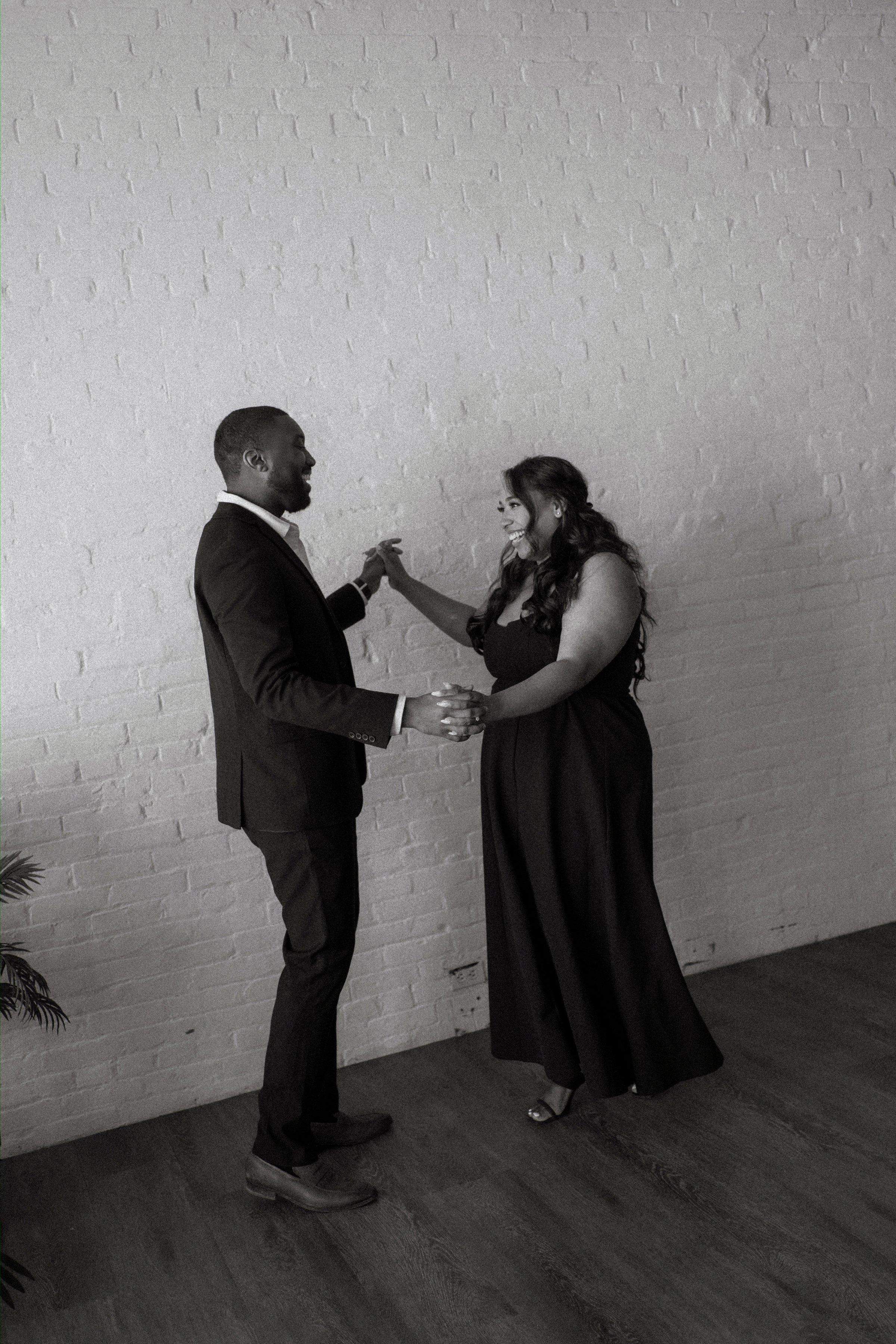Jaida and Jordan close portrait with soft downtown Winnipeg background — engagement photography by Ngo Photography