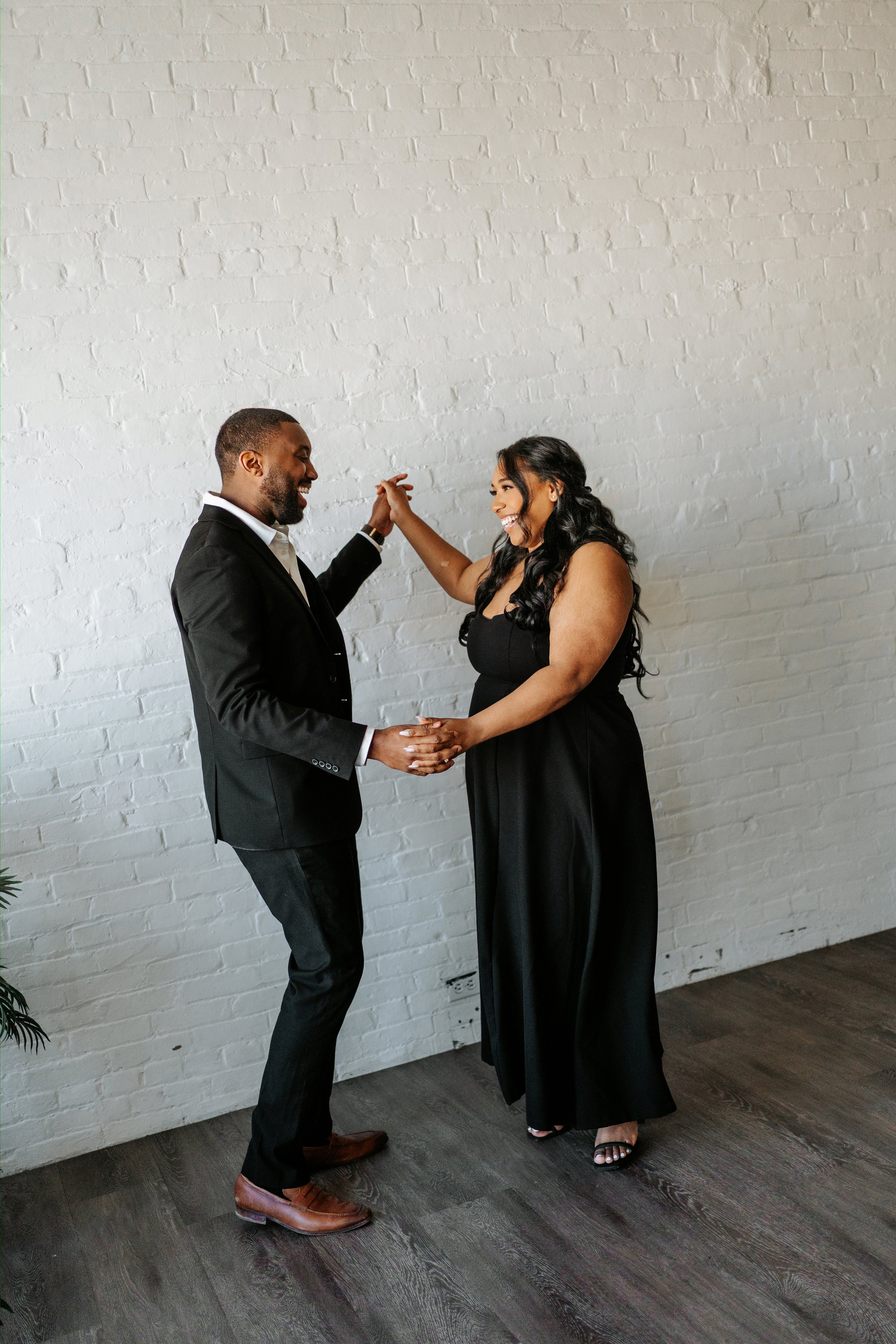 Jordan and Jaida candid moment on a downtown Winnipeg street — engagement session by Chris Ngo