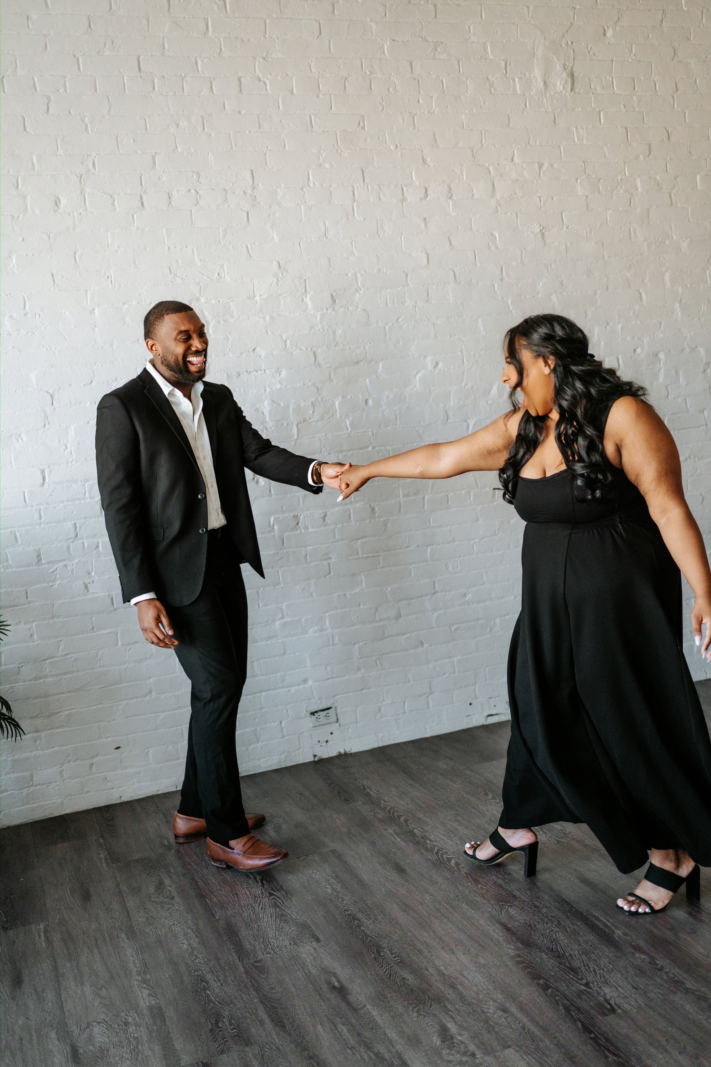 Jaida and Jordan walking hand in hand through downtown Winnipeg — engagement photography by Chris Ngo