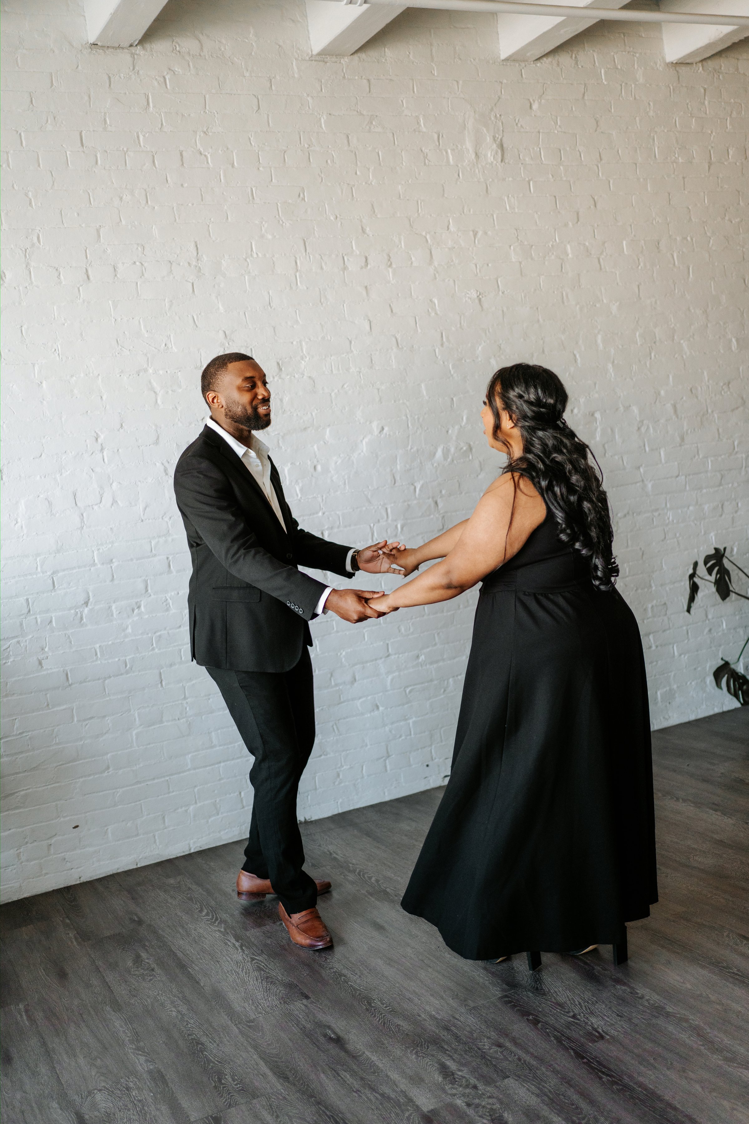 Jaida and Jordan close portrait in downtown Winnipeg with city architecture — engagement photography by Ngo Photography