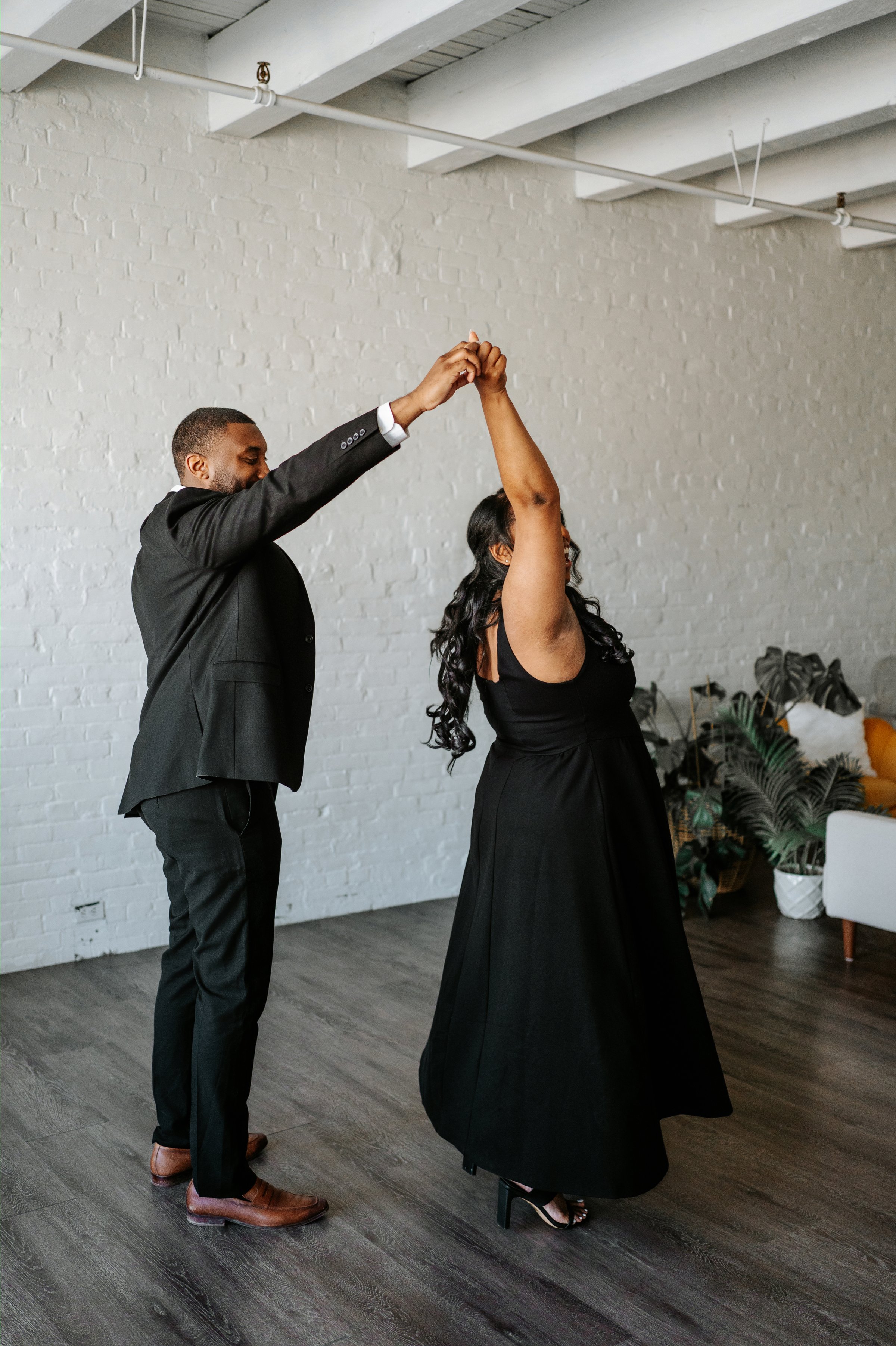 Jaida and Jordan walking hand in hand through the downtown Winnipeg core — engagement photography by Chris Ngo